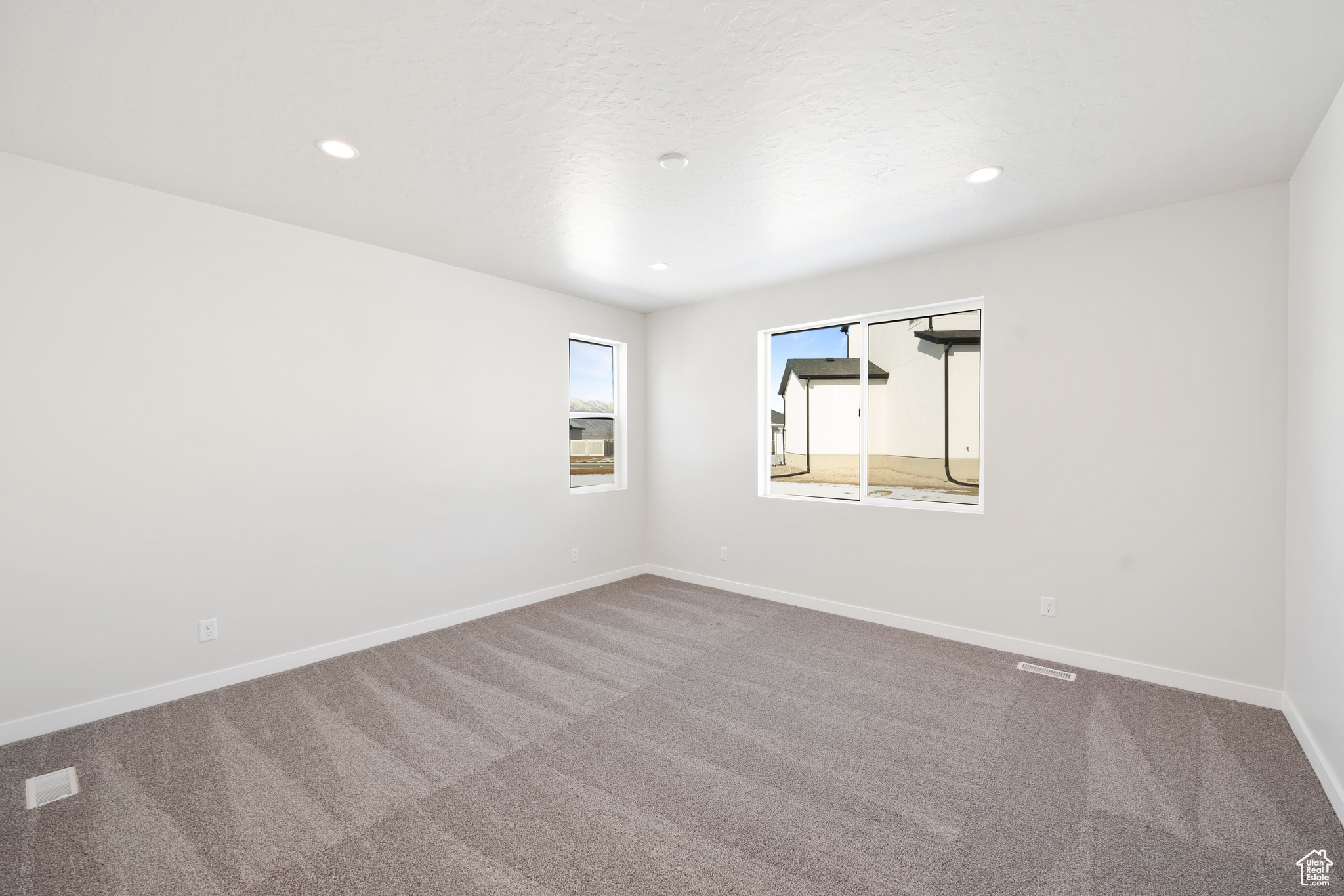Unfurnished room featuring carpet flooring, recessed lighting, and baseboards