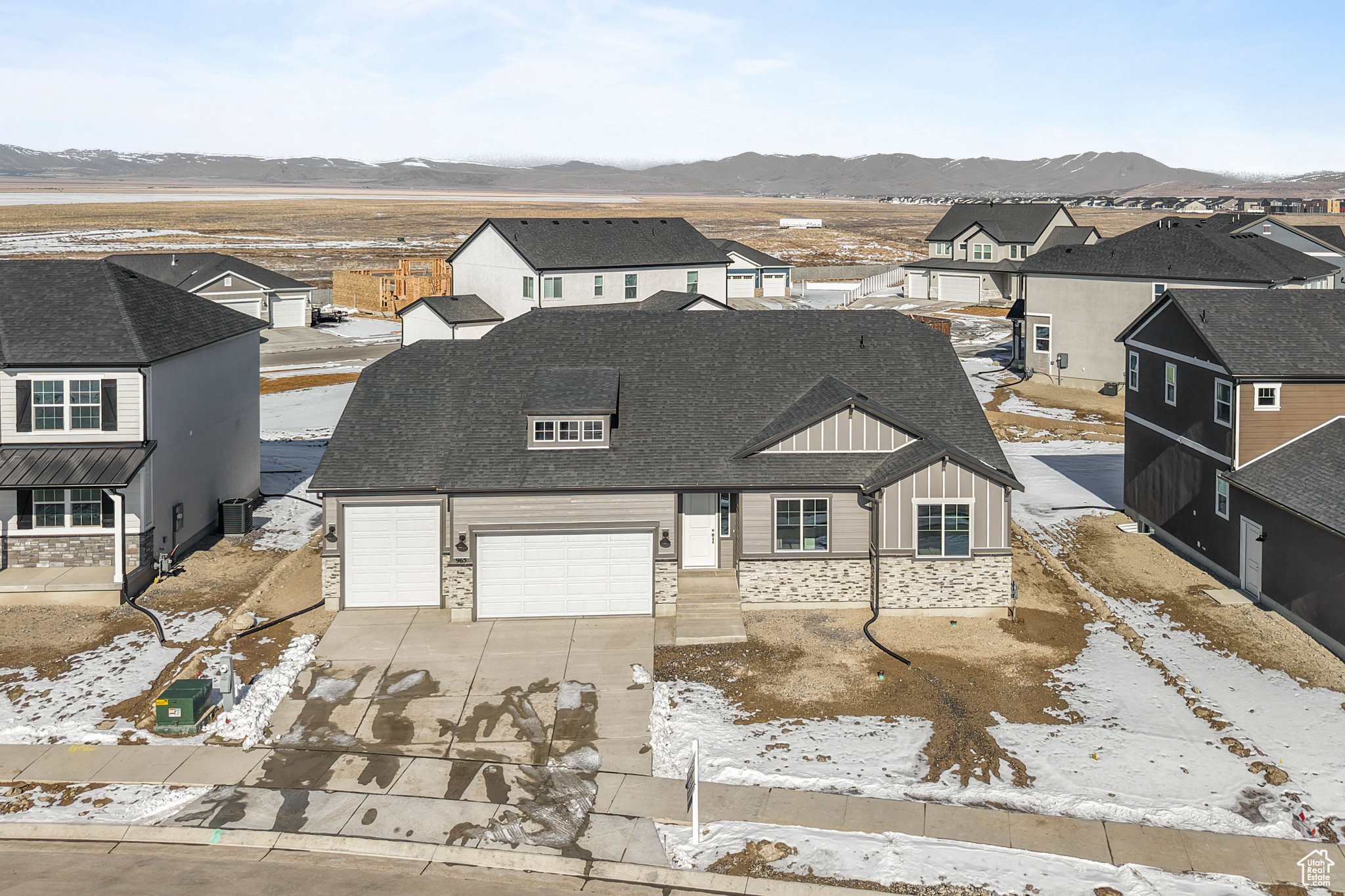 View of front of house with a residential view, a mountain view, concrete driveway, and a shingled roof