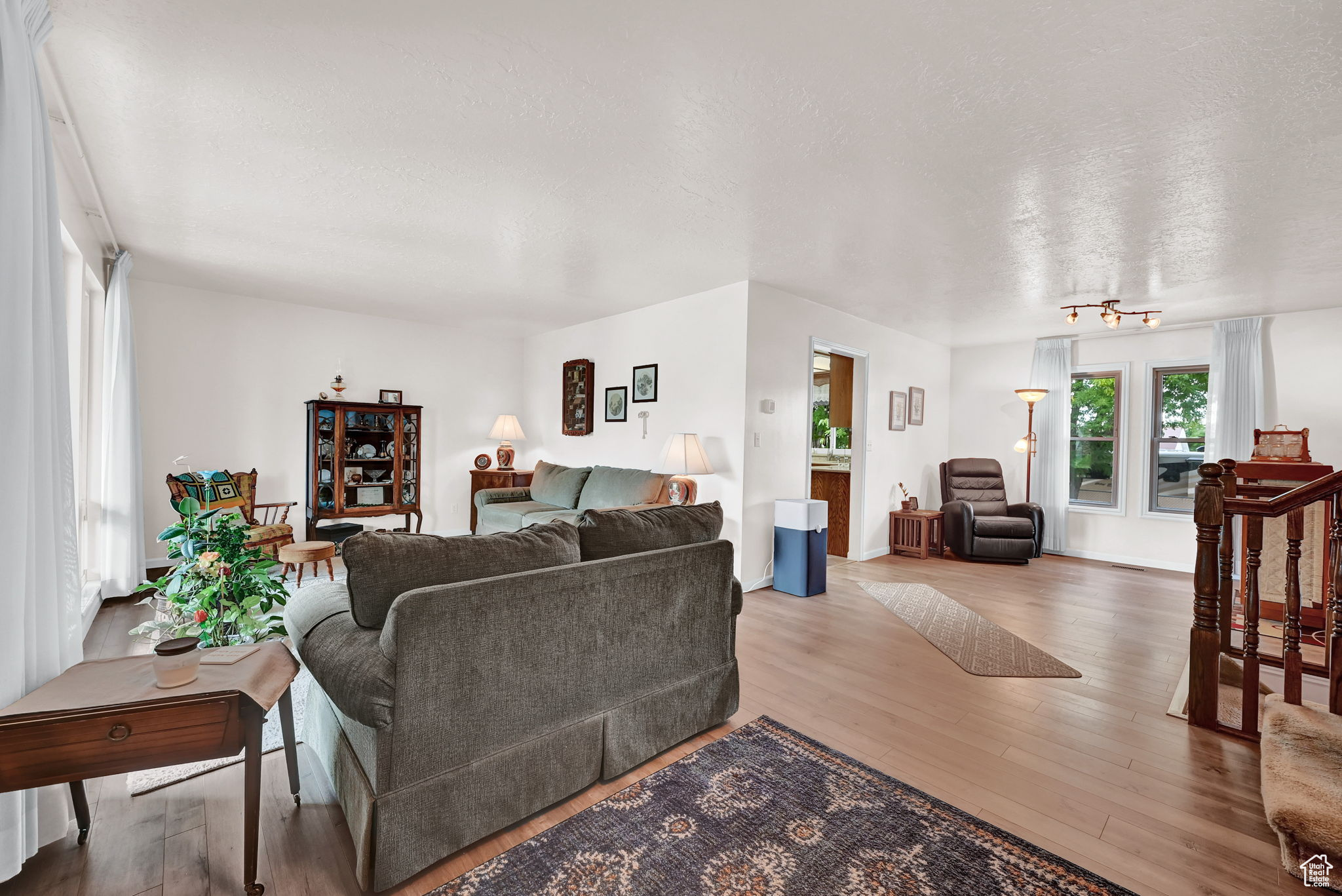 Living area featuring wood finished floors and a textured ceiling