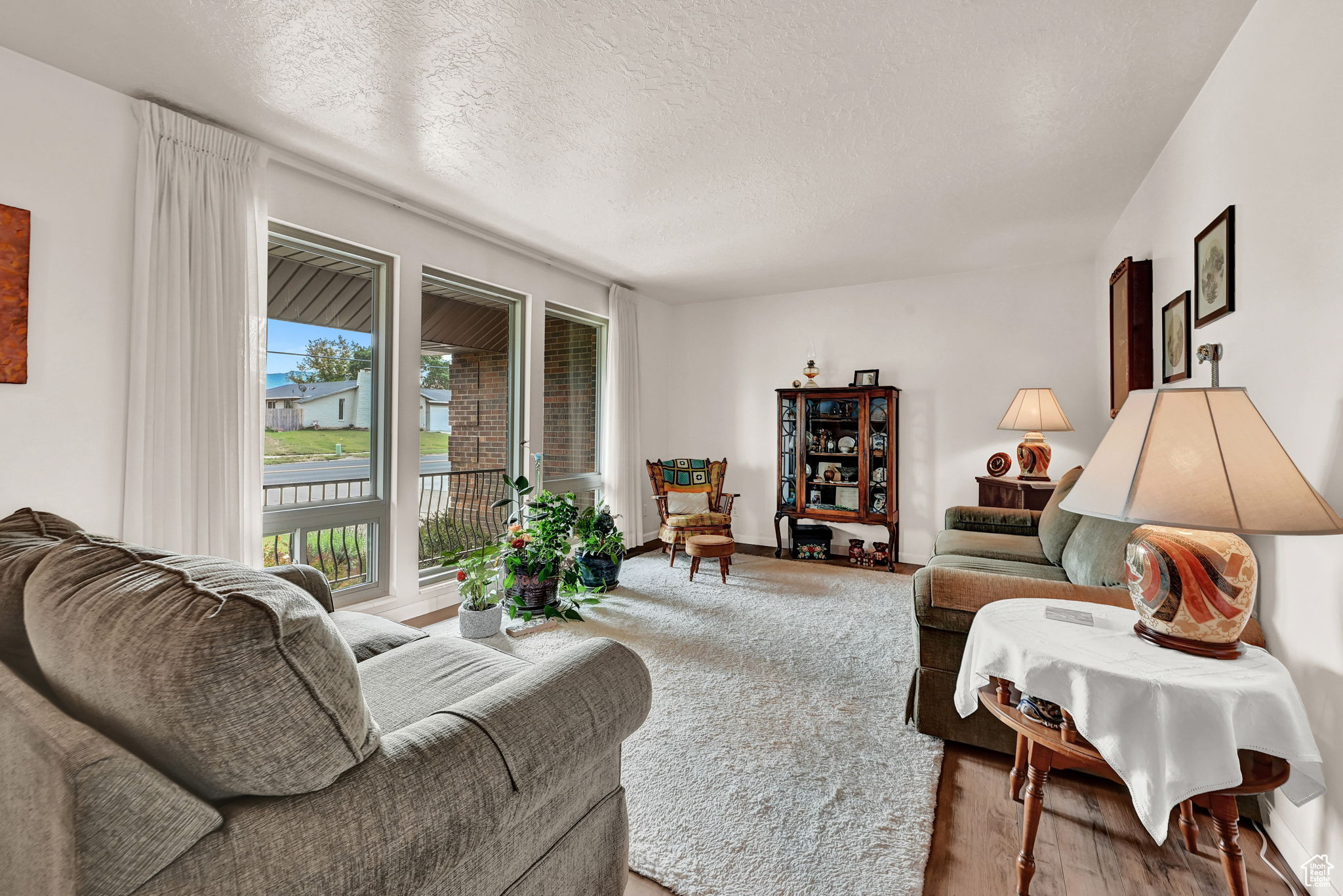Living room featuring wood finished floors and a textured ceiling