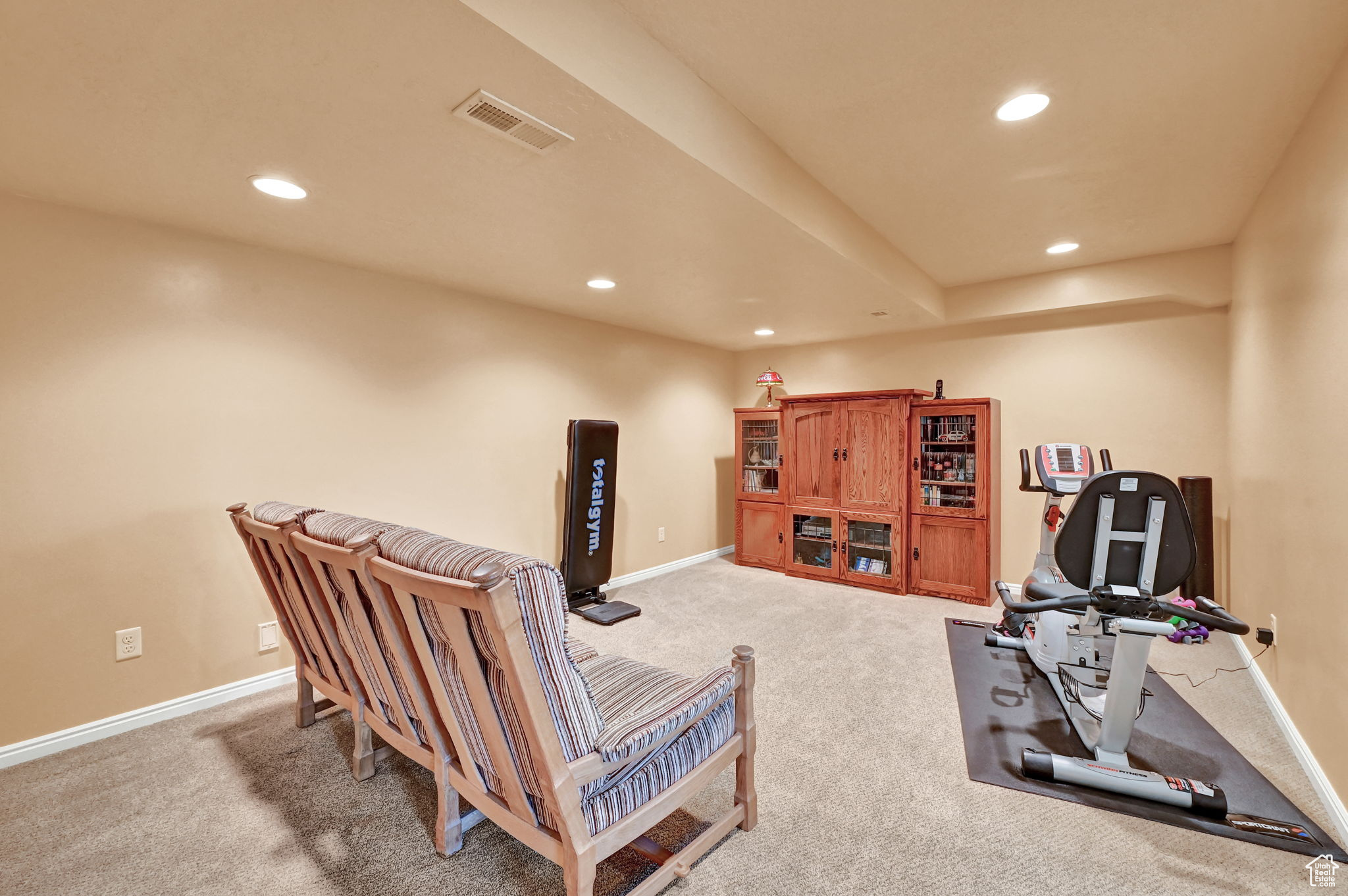 Exercise room featuring carpet flooring, recessed lighting, and visible vents