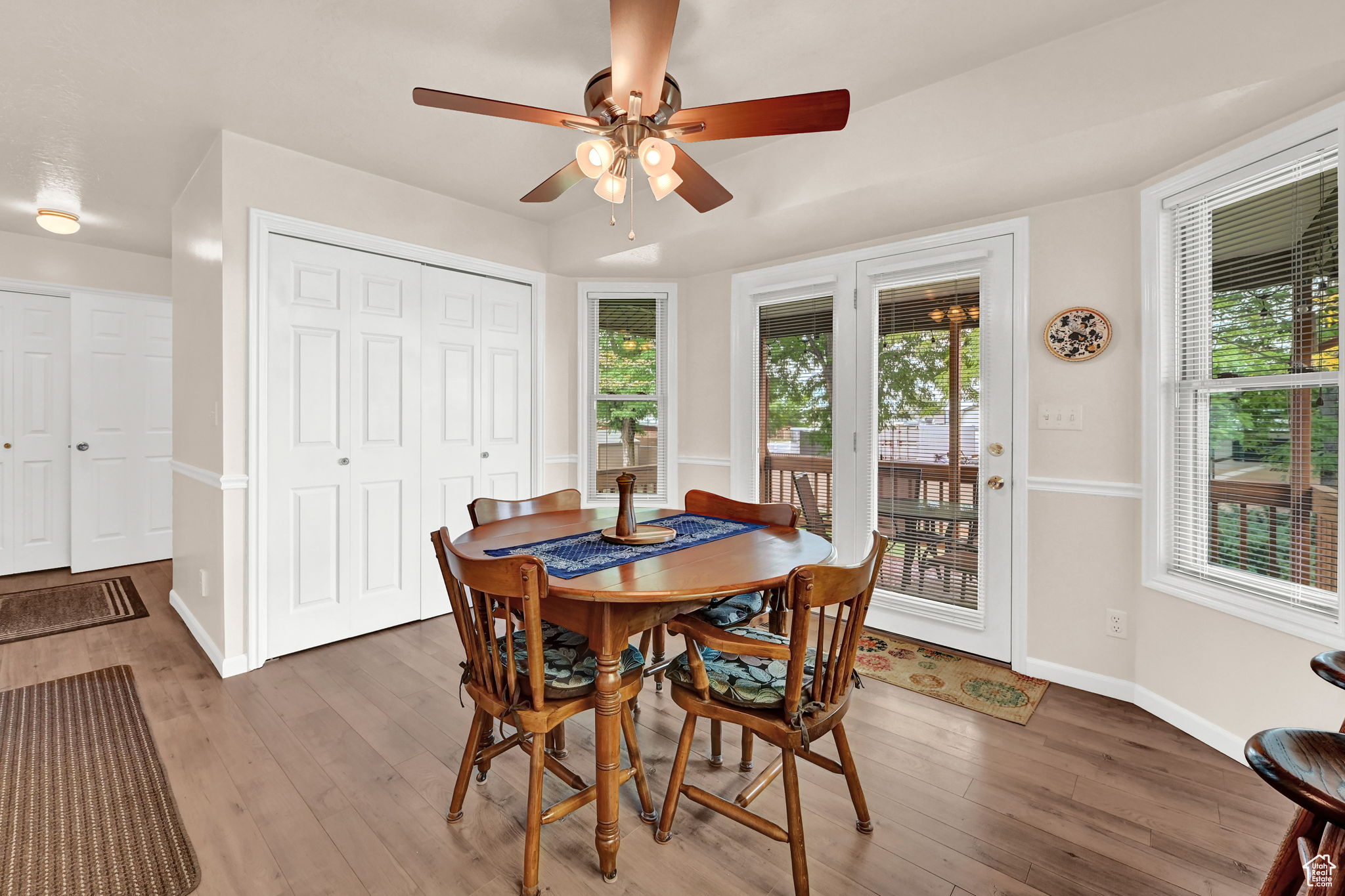 Dining area with a wealth of natural light, baseboards, and light wood-style flooring
