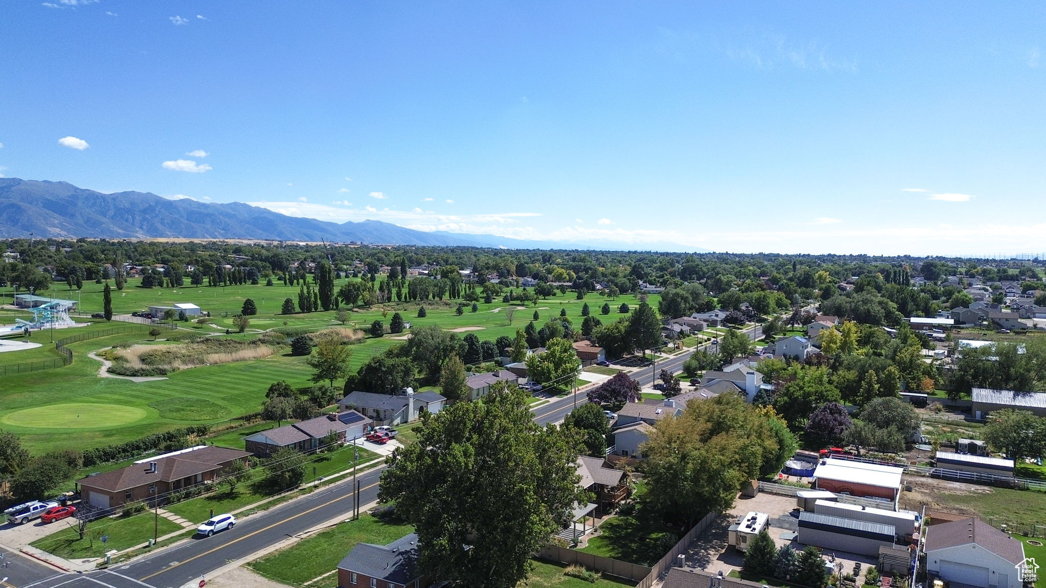 Drone / aerial view with a mountain view and view of golf course