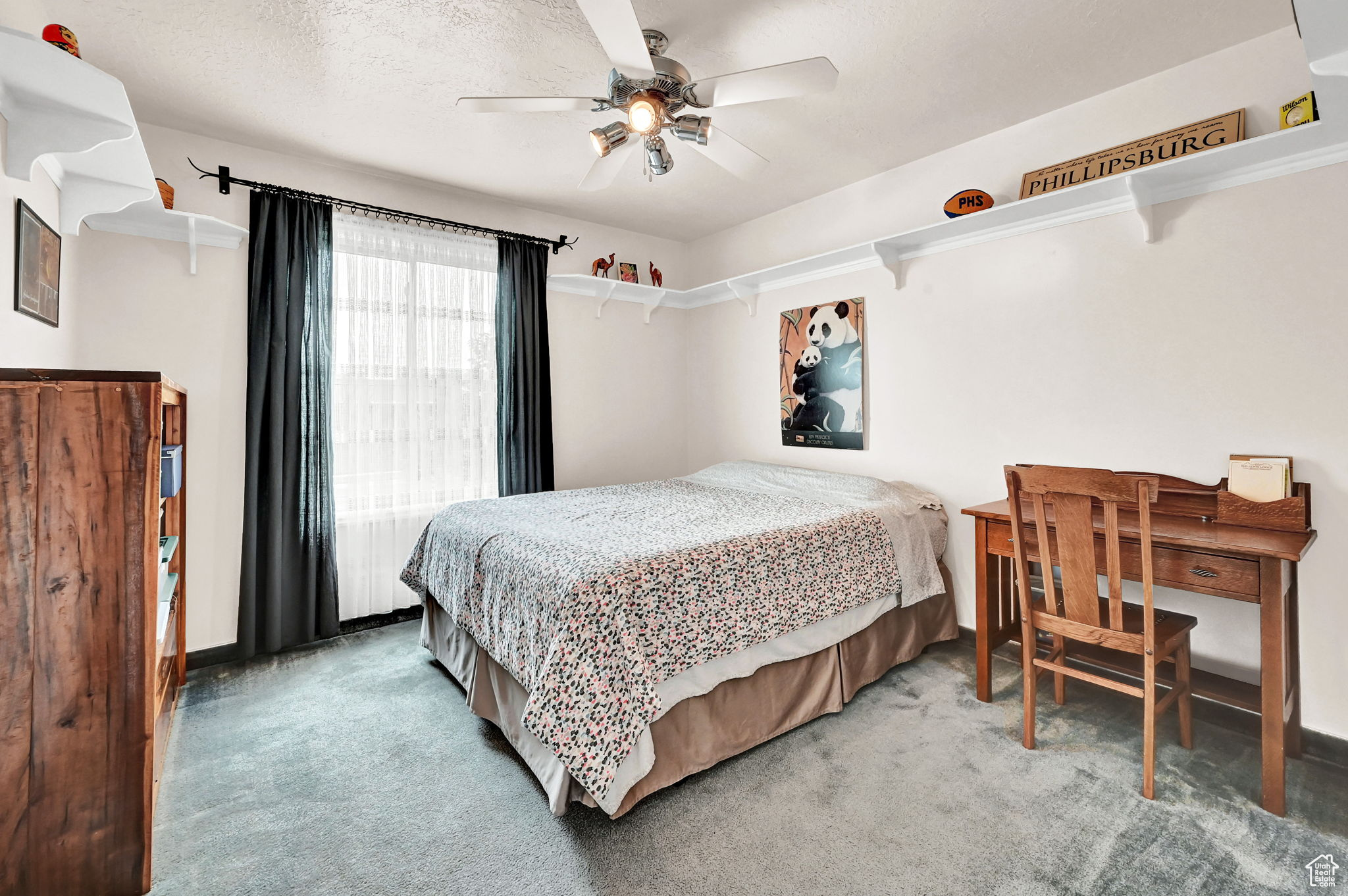 Carpeted bedroom with a textured ceiling and ceiling fan