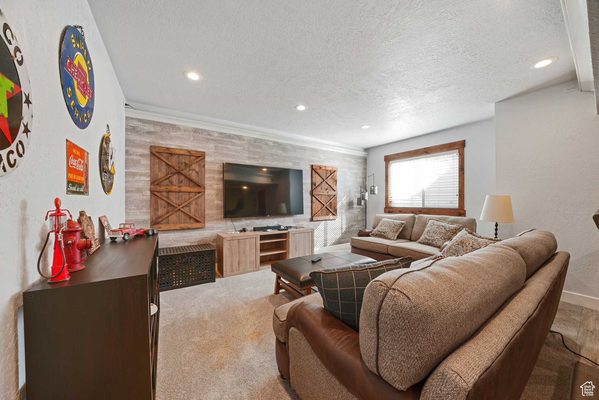 Living room featuring carpet, recessed lighting, baseboards, and a textured ceiling