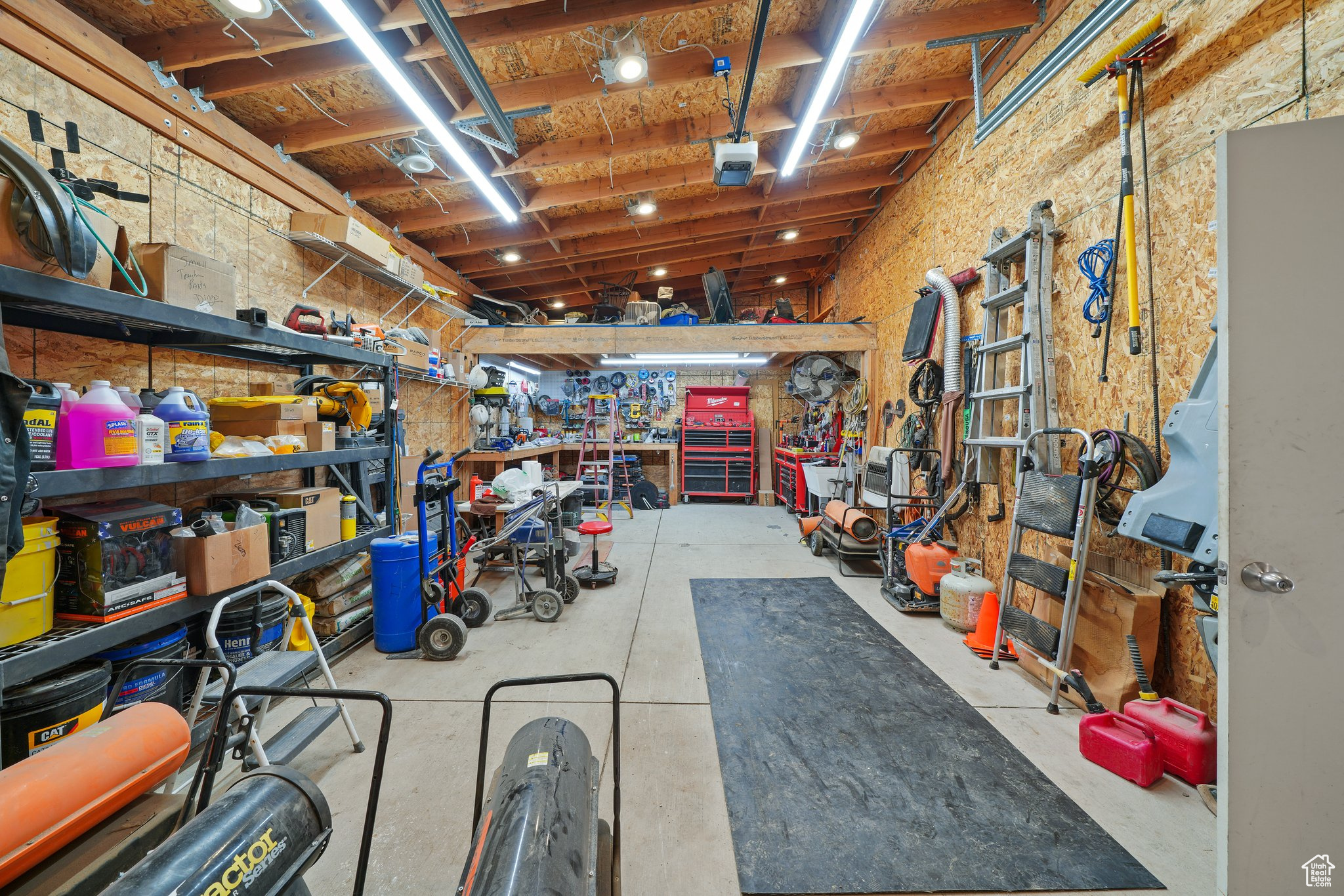 Garage with a workshop area and a garage door opener