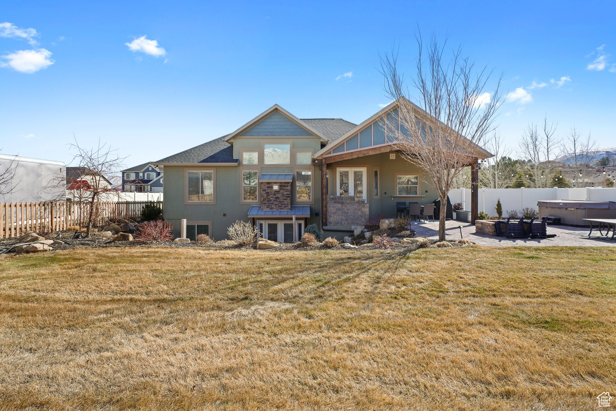 Rear view of house with a yard, a patio, and a fenced backyard