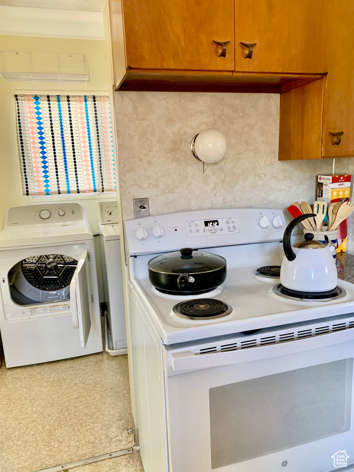Clothes washing area featuring independent washer and dryer and laundry area