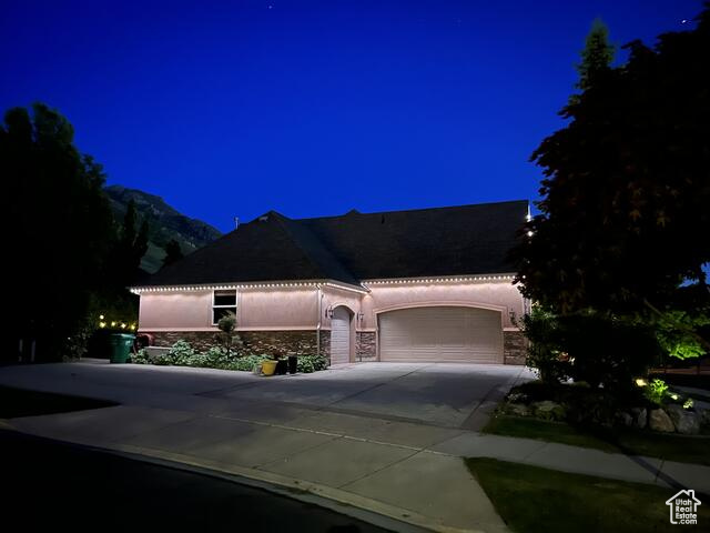 View of 3 car garage at twilight
