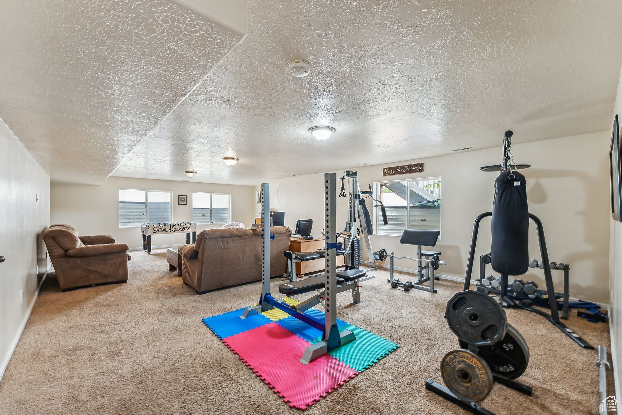Exercise area featuring baseboards and carpet floors