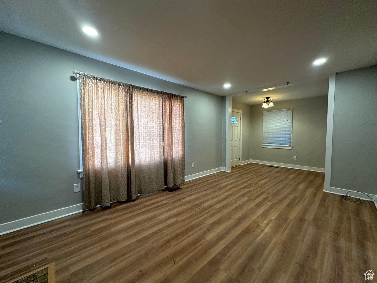 Empty room with recessed lighting, visible vents, baseboards, and wood finished floors