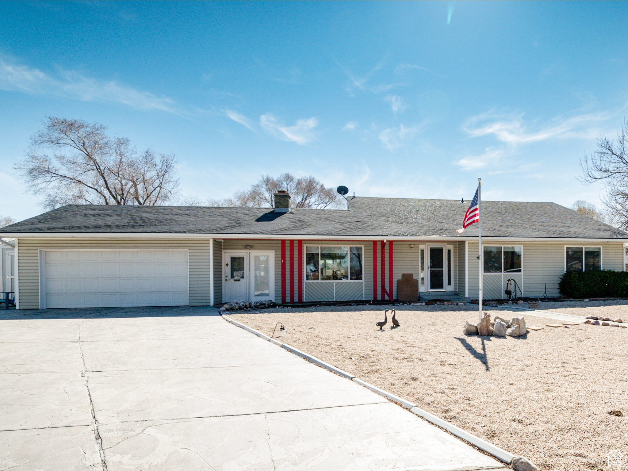 Ranch-style home featuring concrete driveway and attached double garage