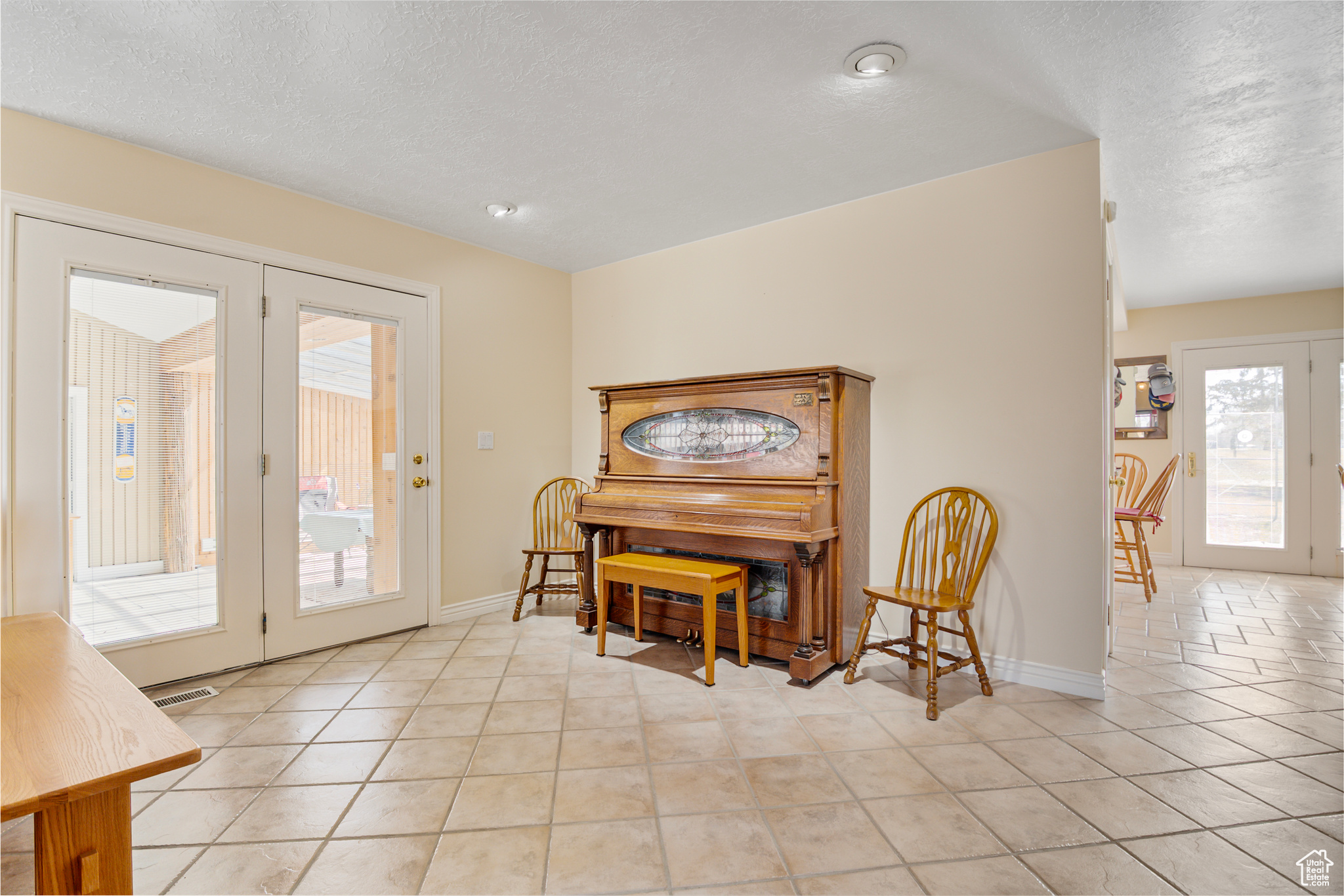 Dining space with light tile floors, french doors