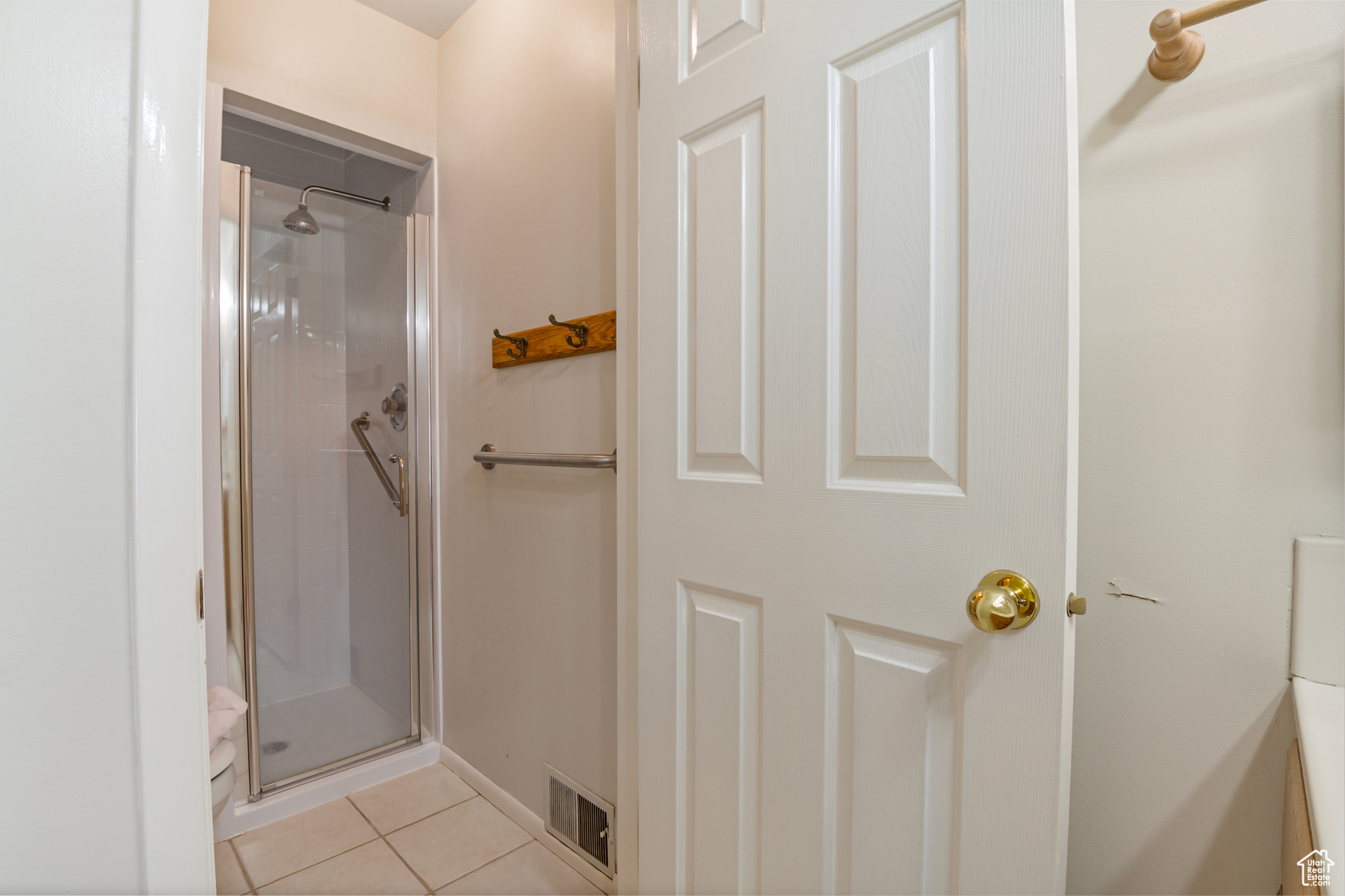 Primary Bathroom featuring a shower, and tile flooring
