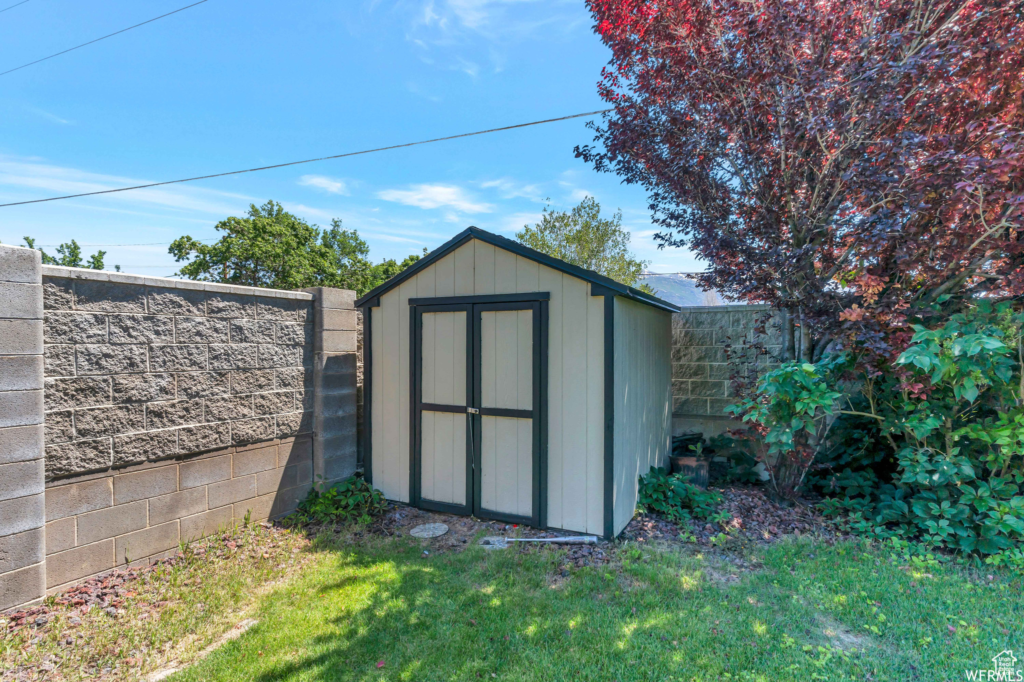 View of shed featuring a fenced backyard