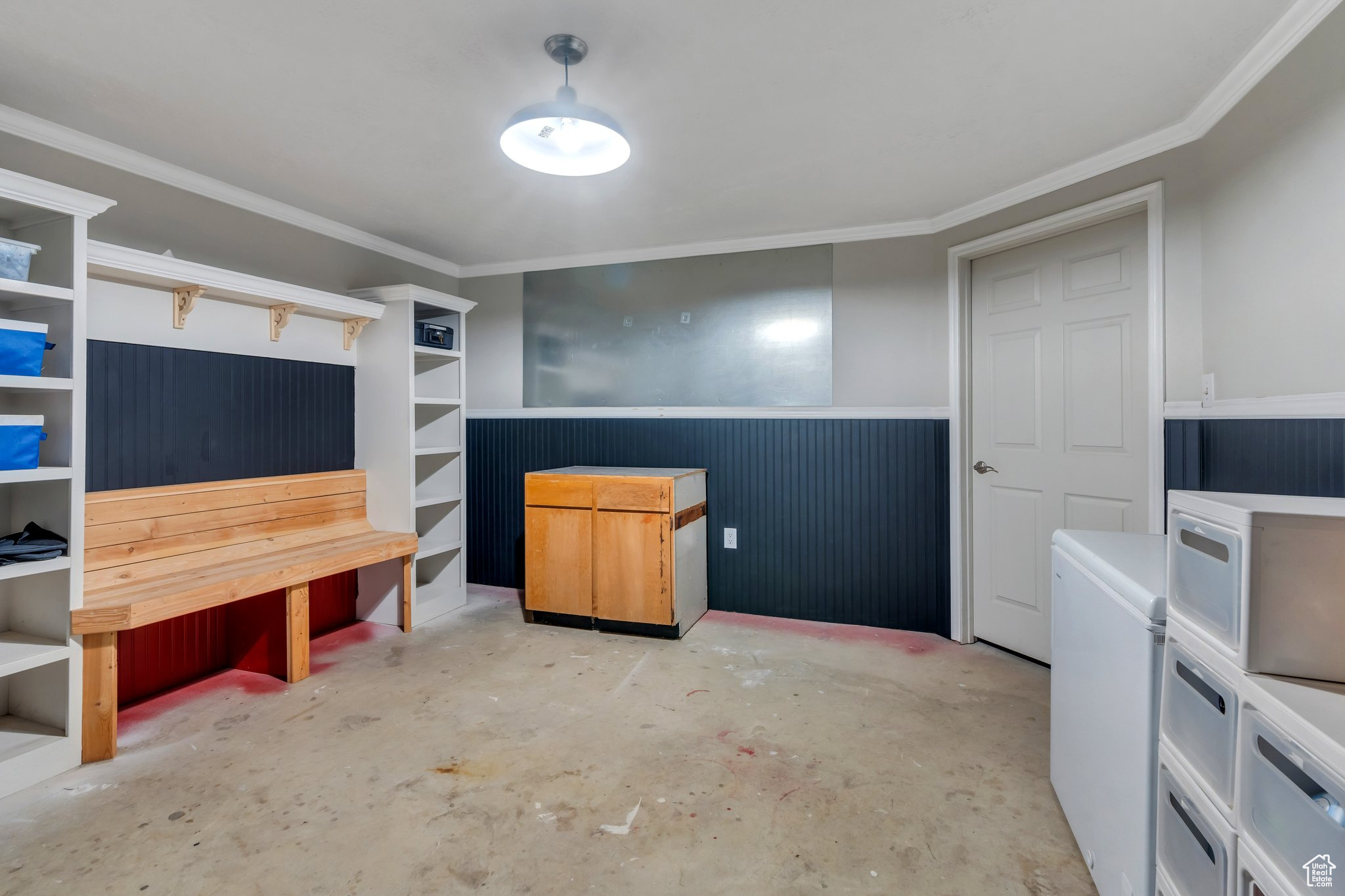 Interior space featuring unfinished concrete floors and crown molding