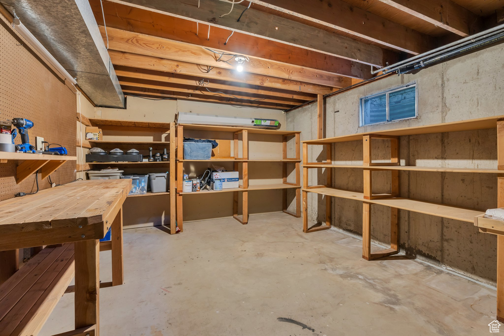 Unfinished below grade area featuring a workshop area