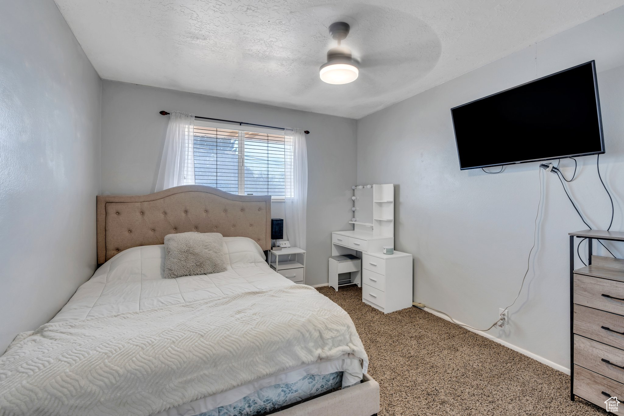 Bedroom featuring baseboards, a textured ceiling, ceiling fan, and carpet flooring