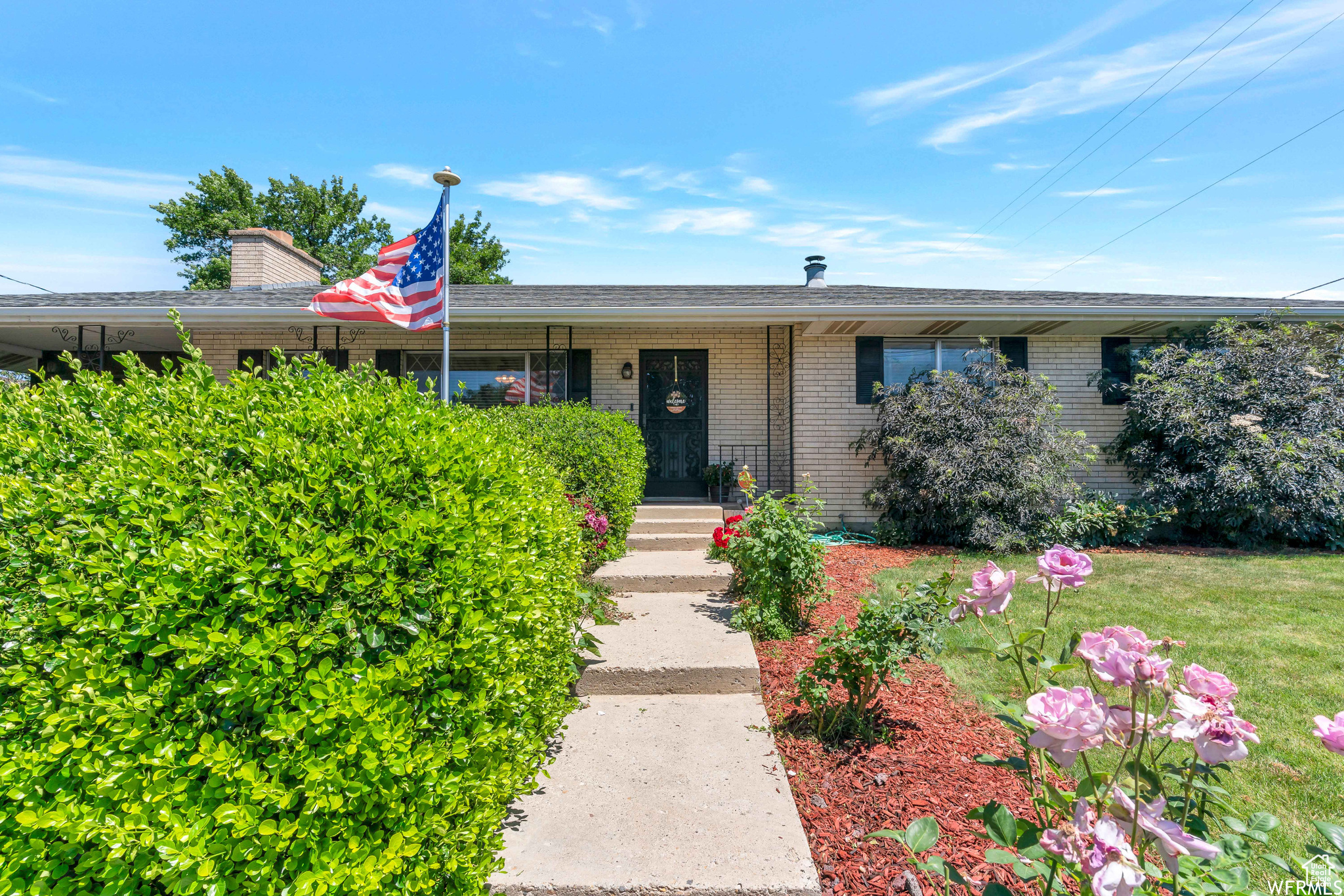 Ranch-style home featuring brick siding and a front lawn