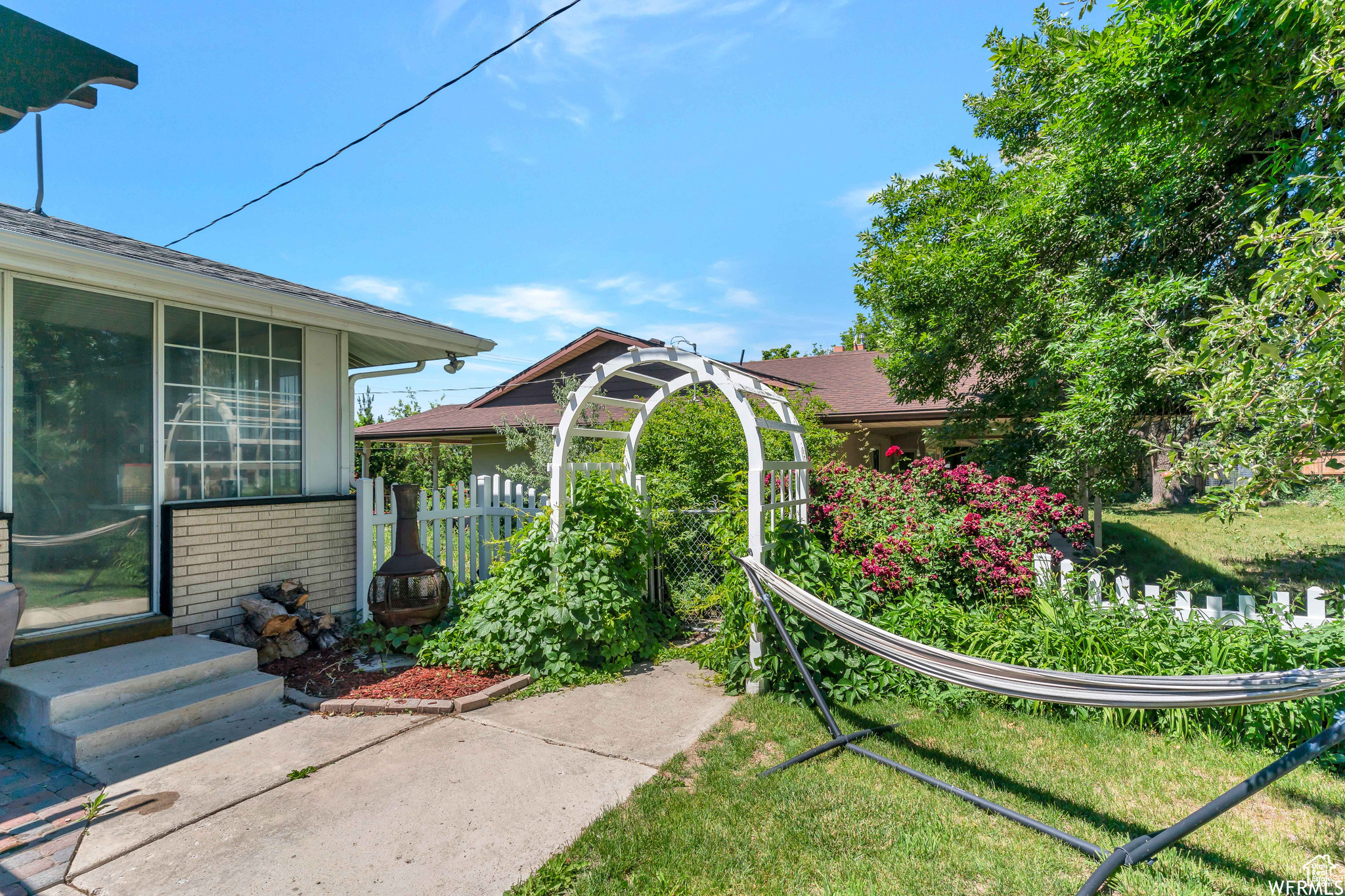 View of yard featuring entry steps and fence