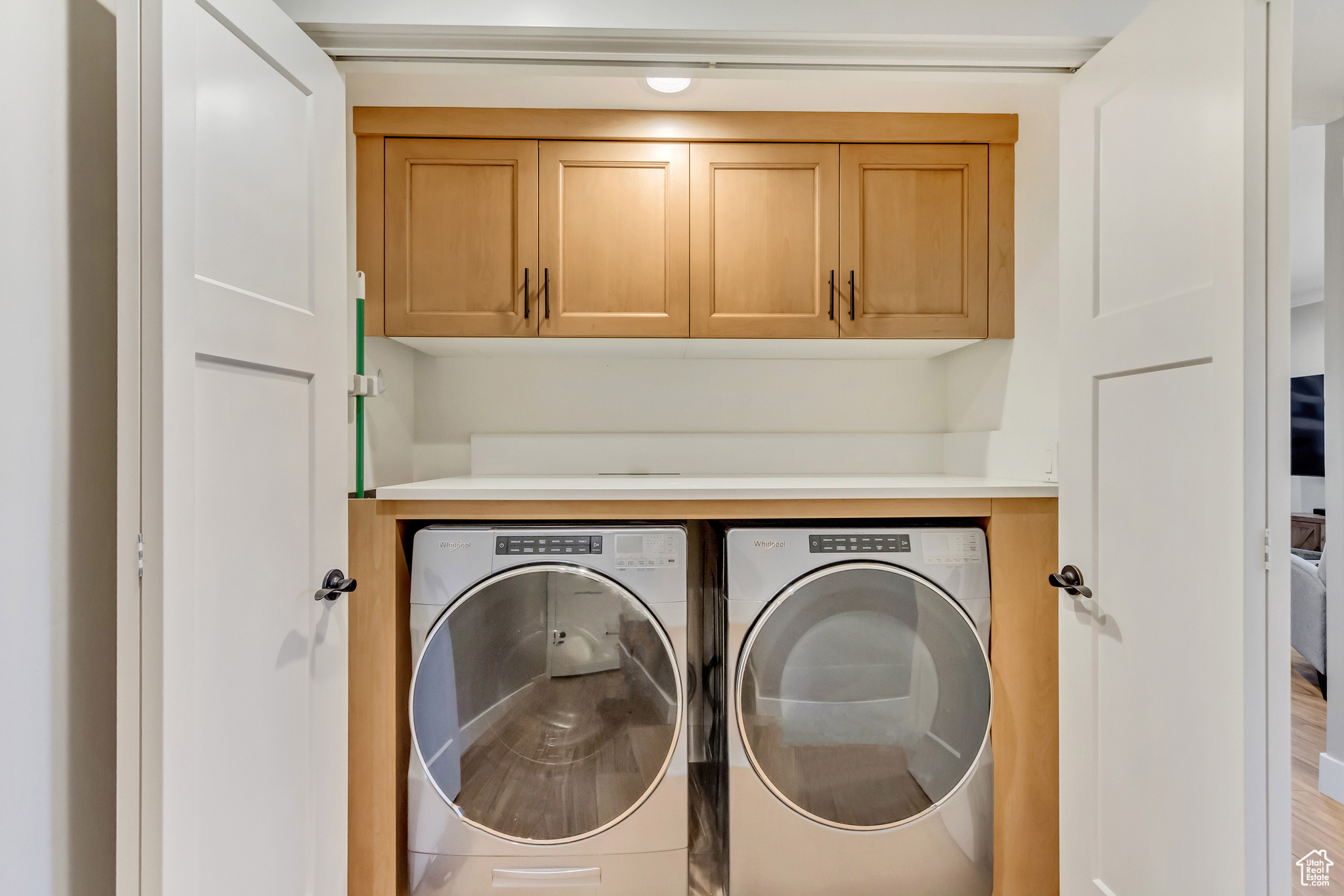 Laundry Closet with storage and countertop in downstairs In-law suite.