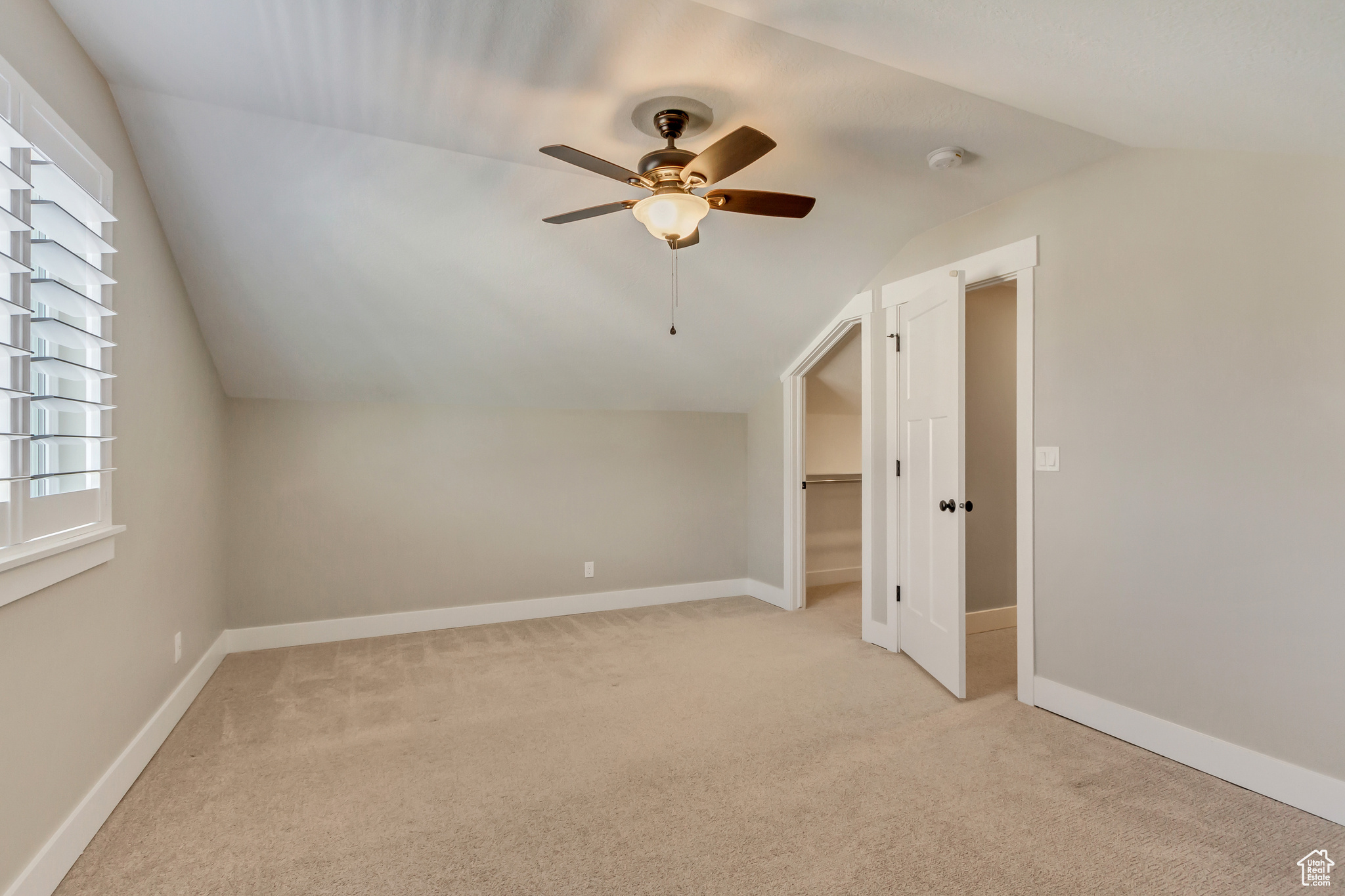 Upstairs bedroom (4) with vaulted ceilings and a walk in closet.