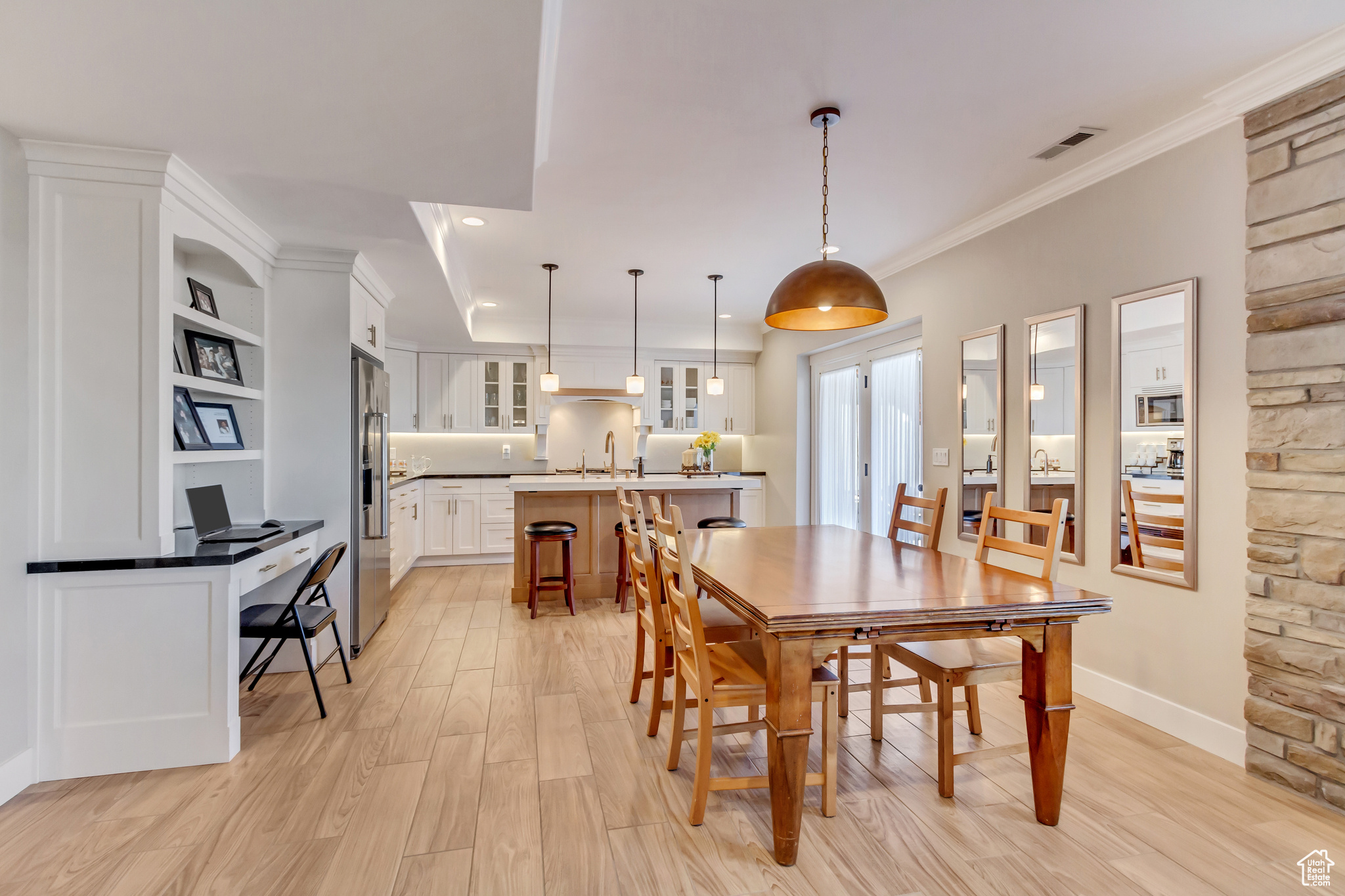 Downstairs In-law suite dining space crown molding, recessed lighting, and light wood-style tile floor.