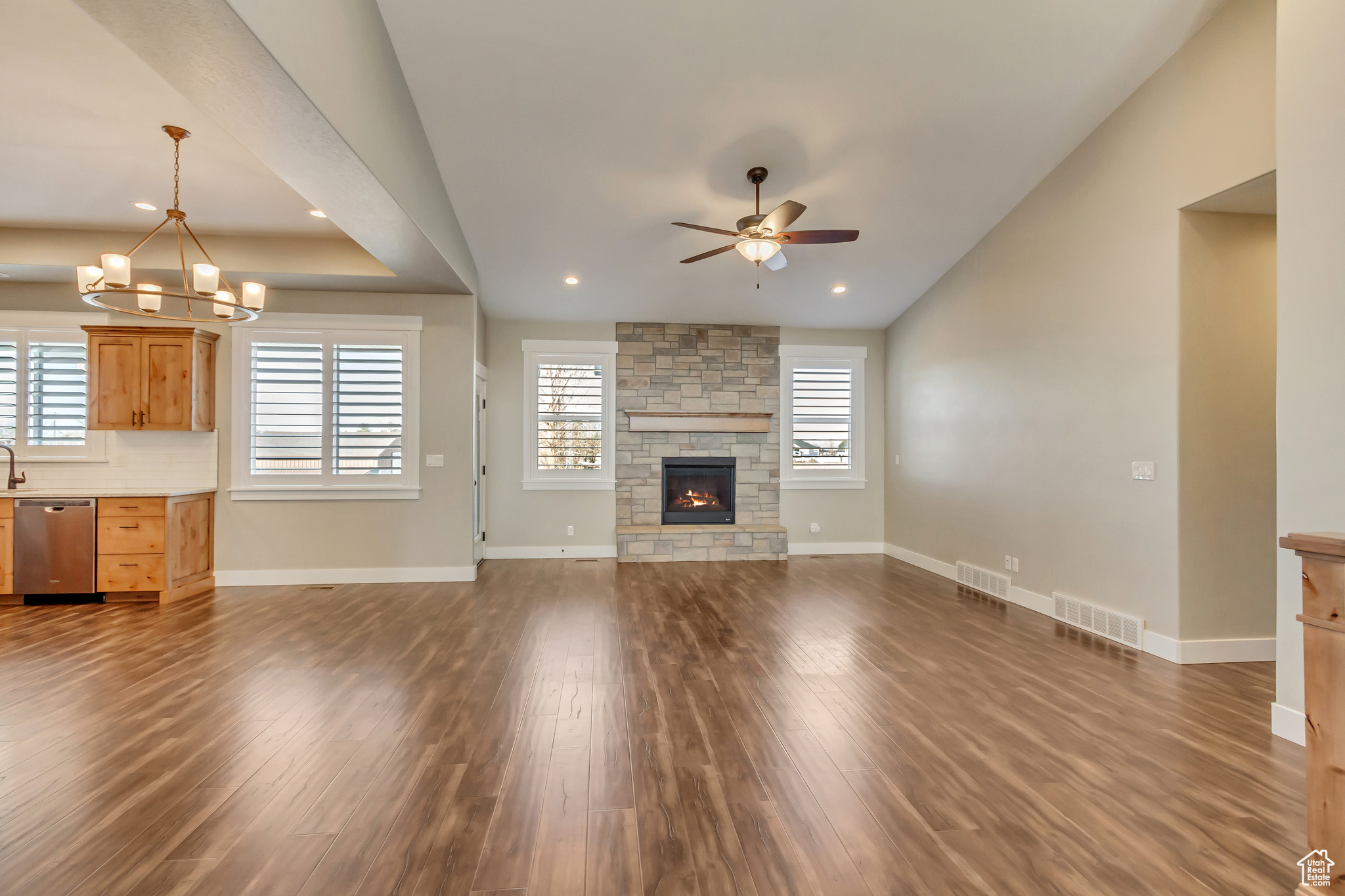 Main floor living room with a wealth of natural light and wood flooring.