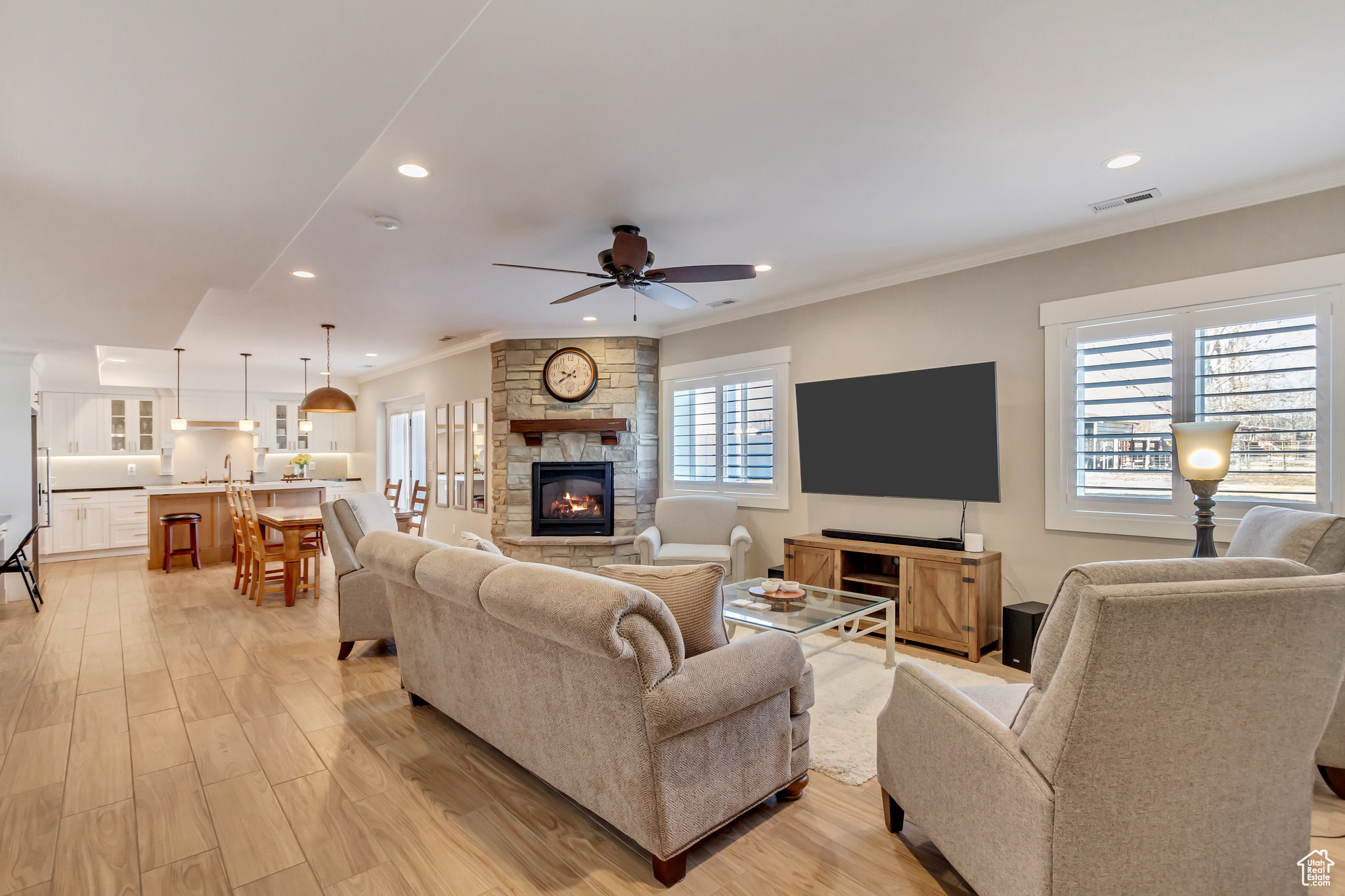 Downstairs In-law suite with plenty of natural light, light wood-style tile floors, and a ceiling fan.
