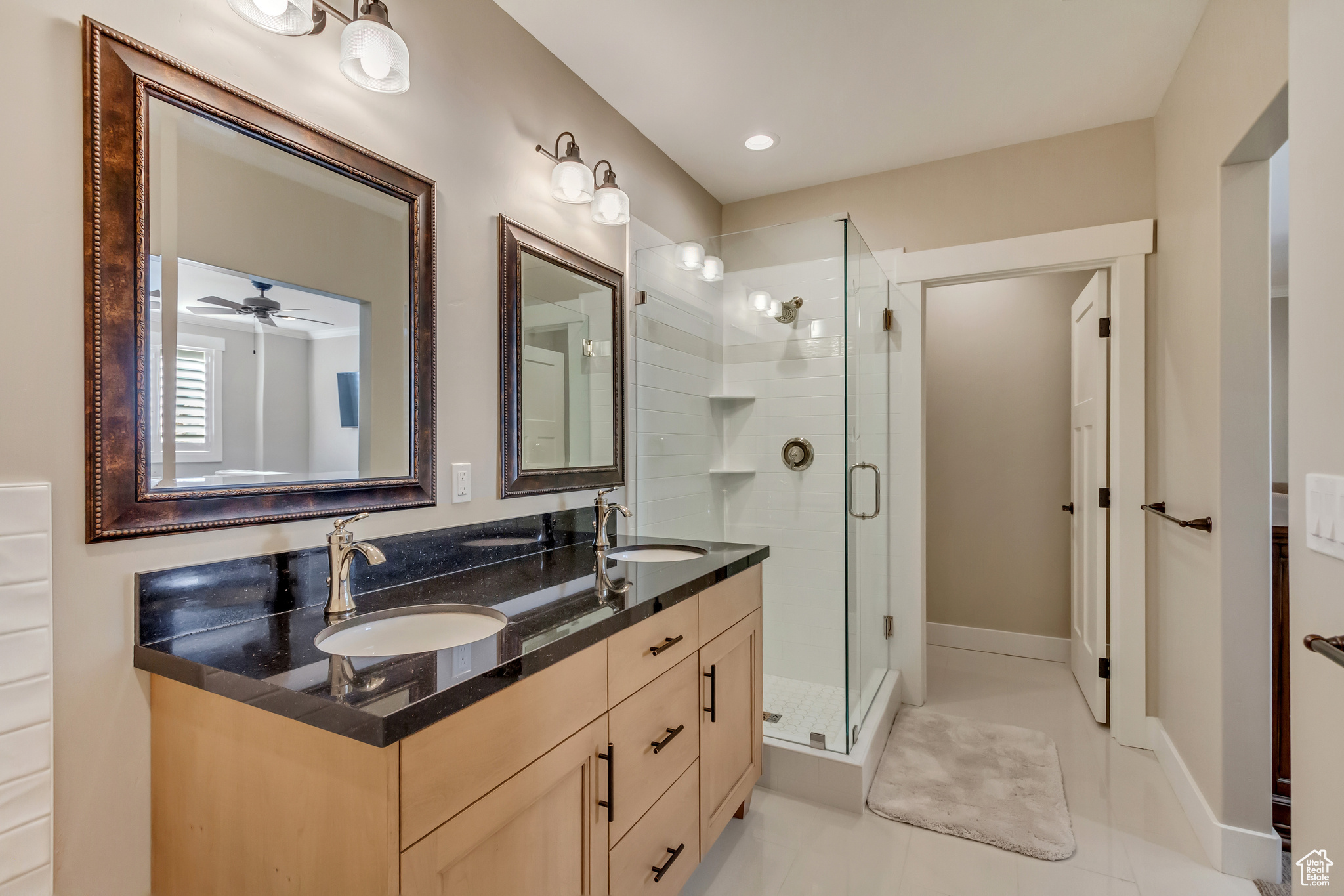 Downstairs In-law suite primary bathroom with double vanity, a stall shower, dual vanity.