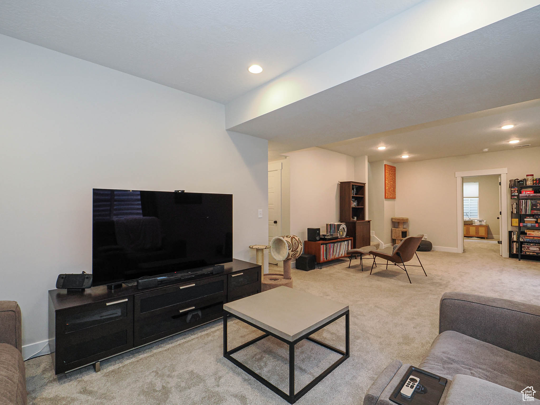 Living room featuring recessed lighting, light colored carpet, and baseboards