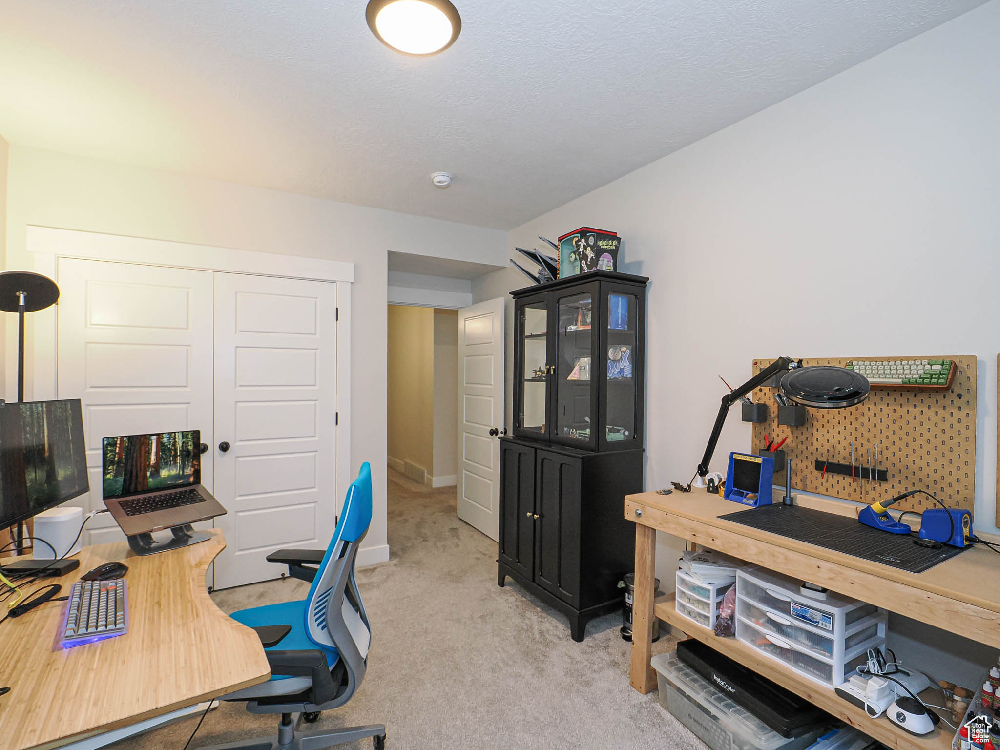Home office featuring baseboards and light colored carpet