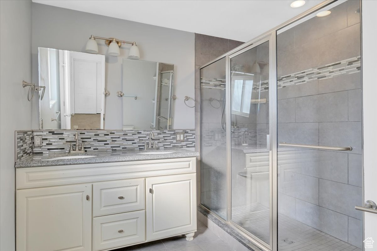 Bathroom with double vanity and shower in primary suite