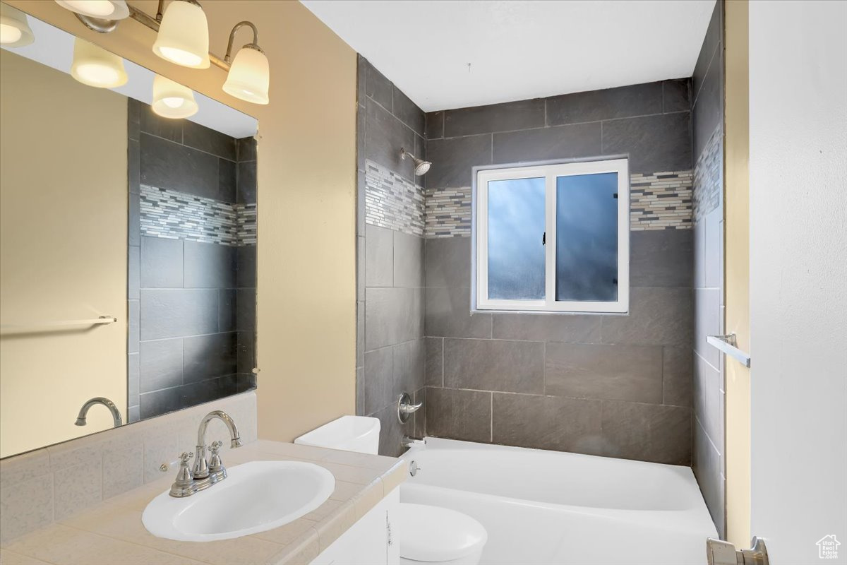 Full bathroom featuring shower / bath combination, toilet, and vanity