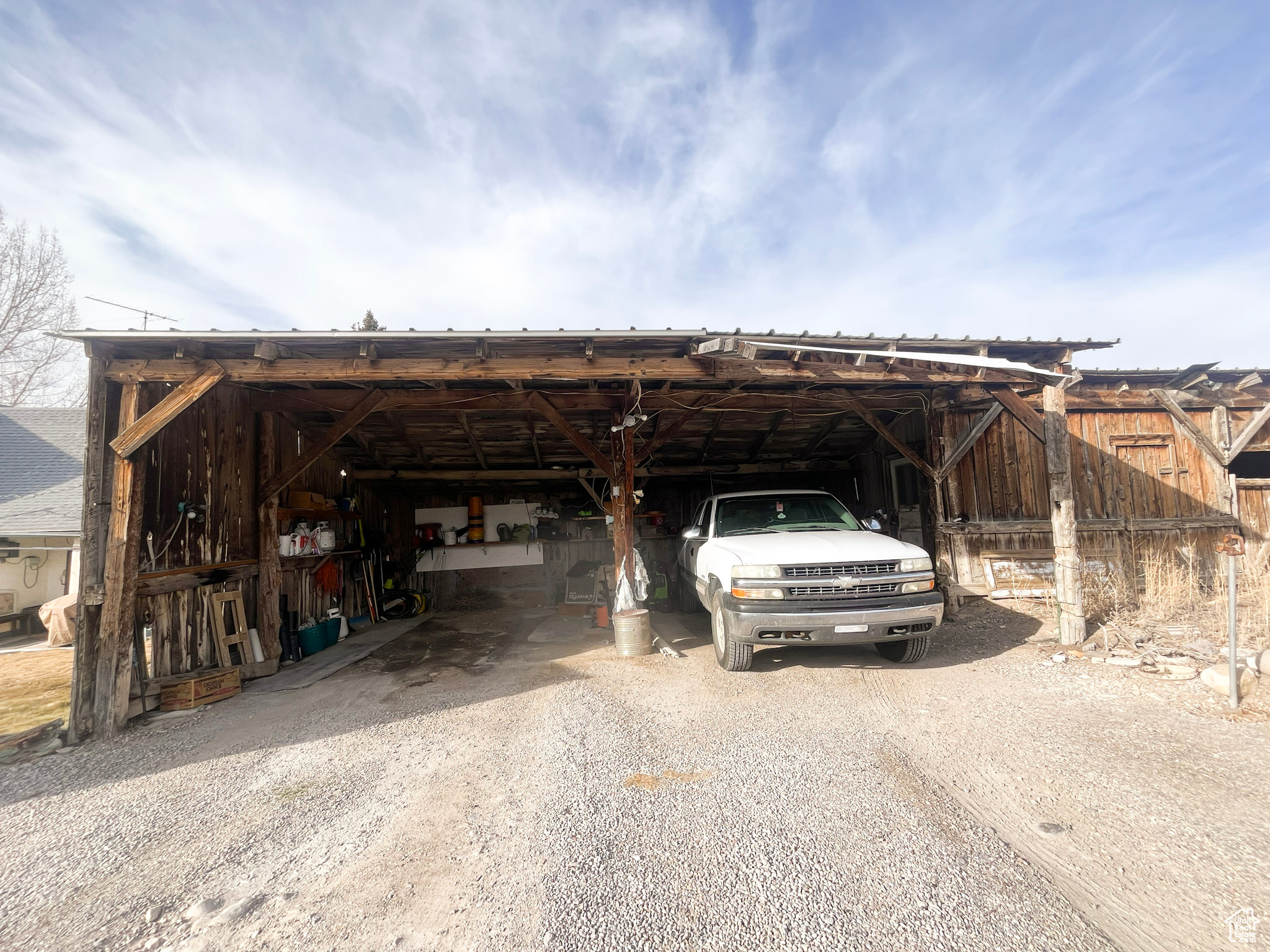 View of car parking featuring a carport and driveway
