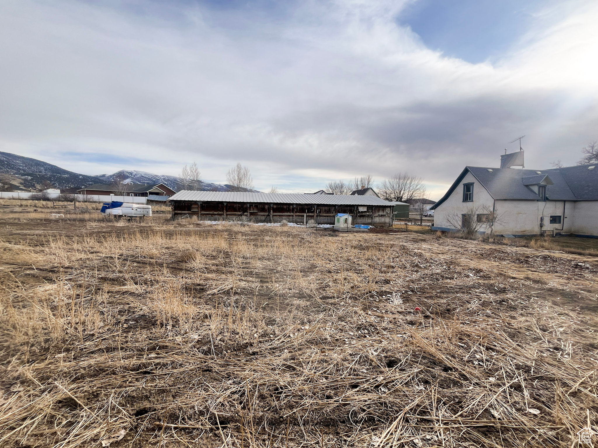 View of yard featuring a mountain view and fence