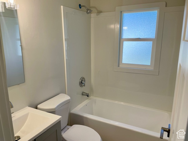 Bathroom with vanity, bathing tub / shower combination, and toilet