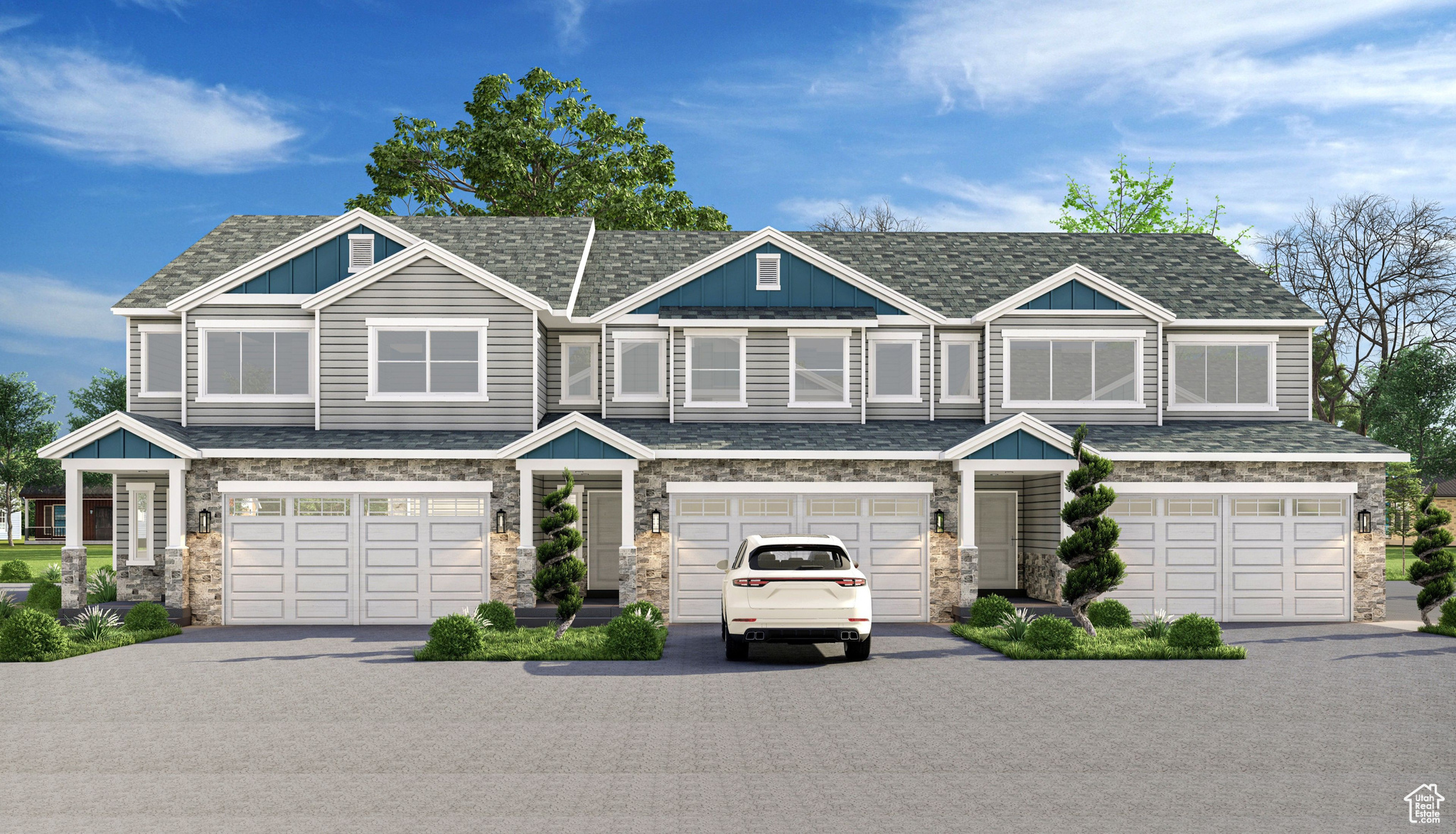 View of front of home featuring stone siding, board and batten siding, driveway, and a garage