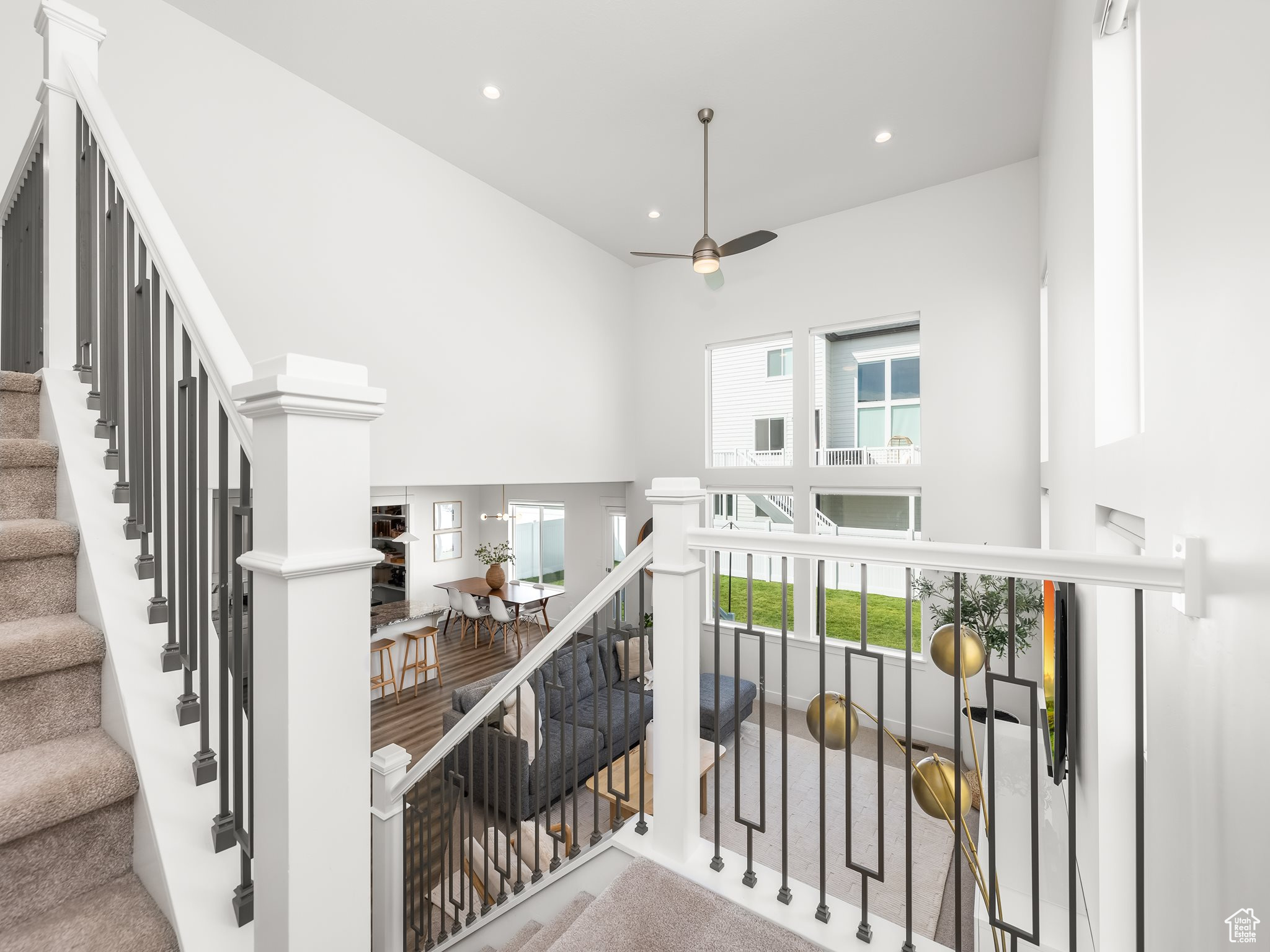 Stairway featuring recessed lighting, ornate columns, a towering ceiling, and ceiling fan
