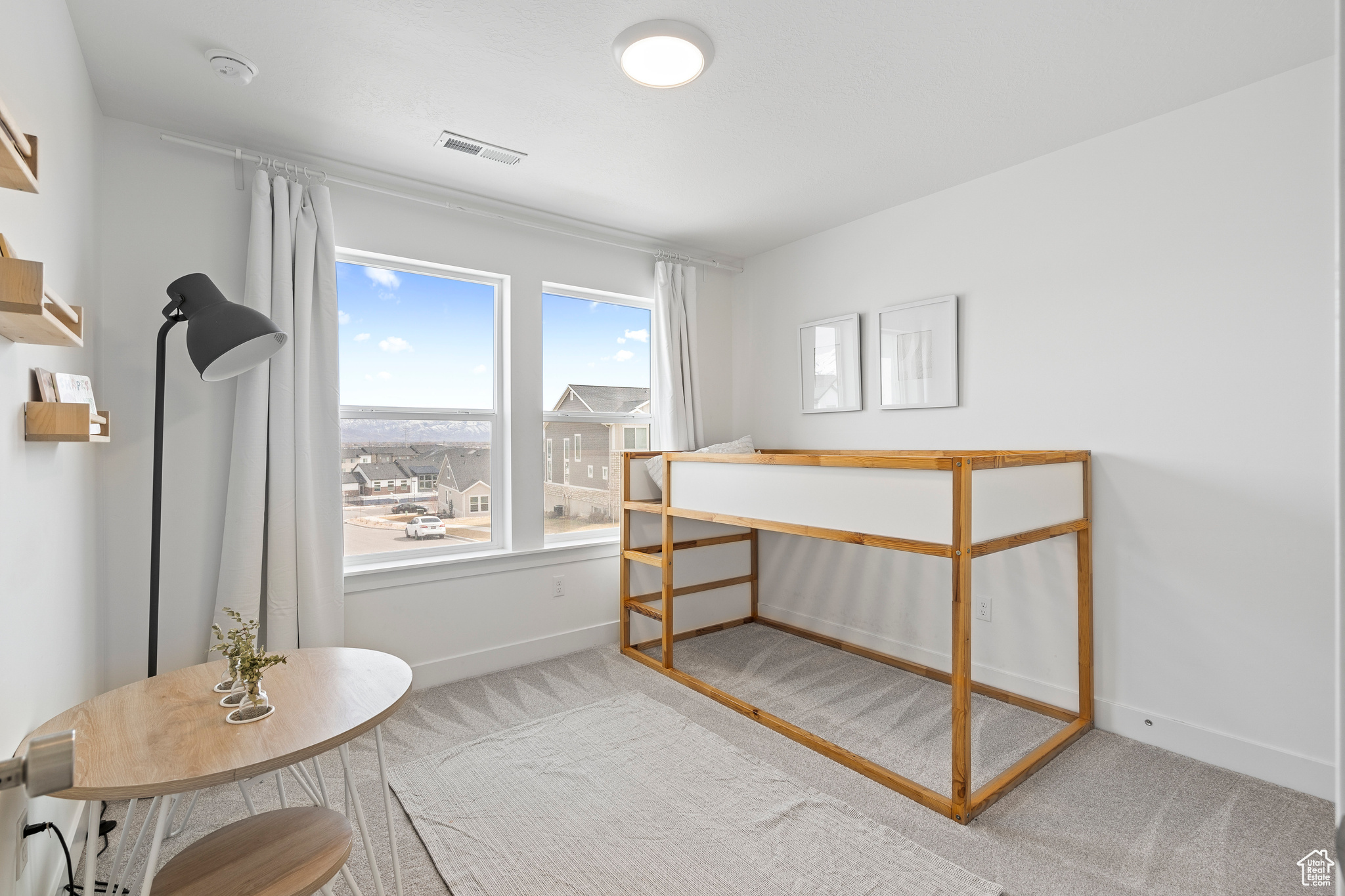 Bedroom with visible vents, baseboards, and carpet flooring