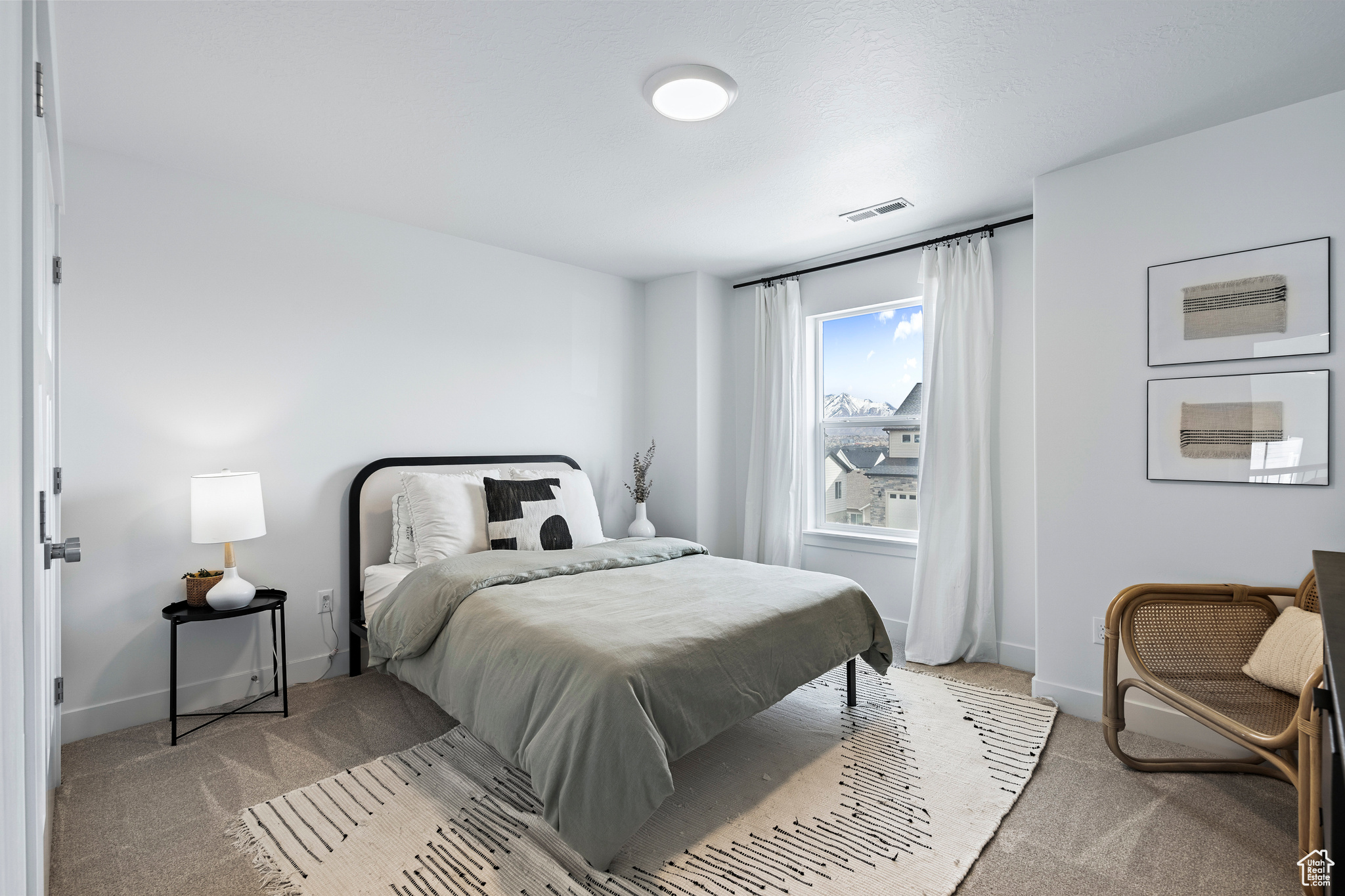 Bedroom with visible vents, baseboards, and carpet