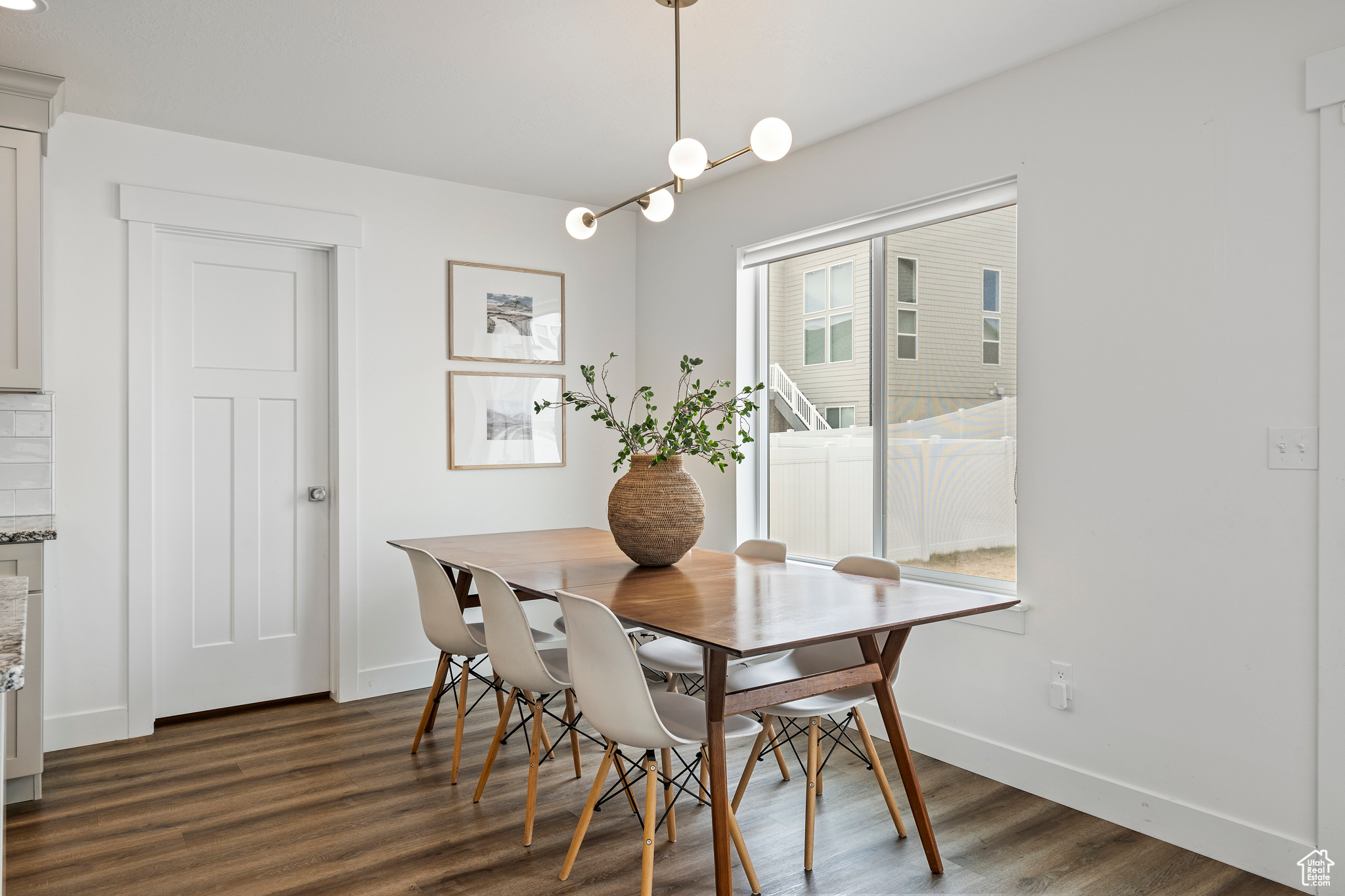 Dining area with baseboards and dark wood-style flooring