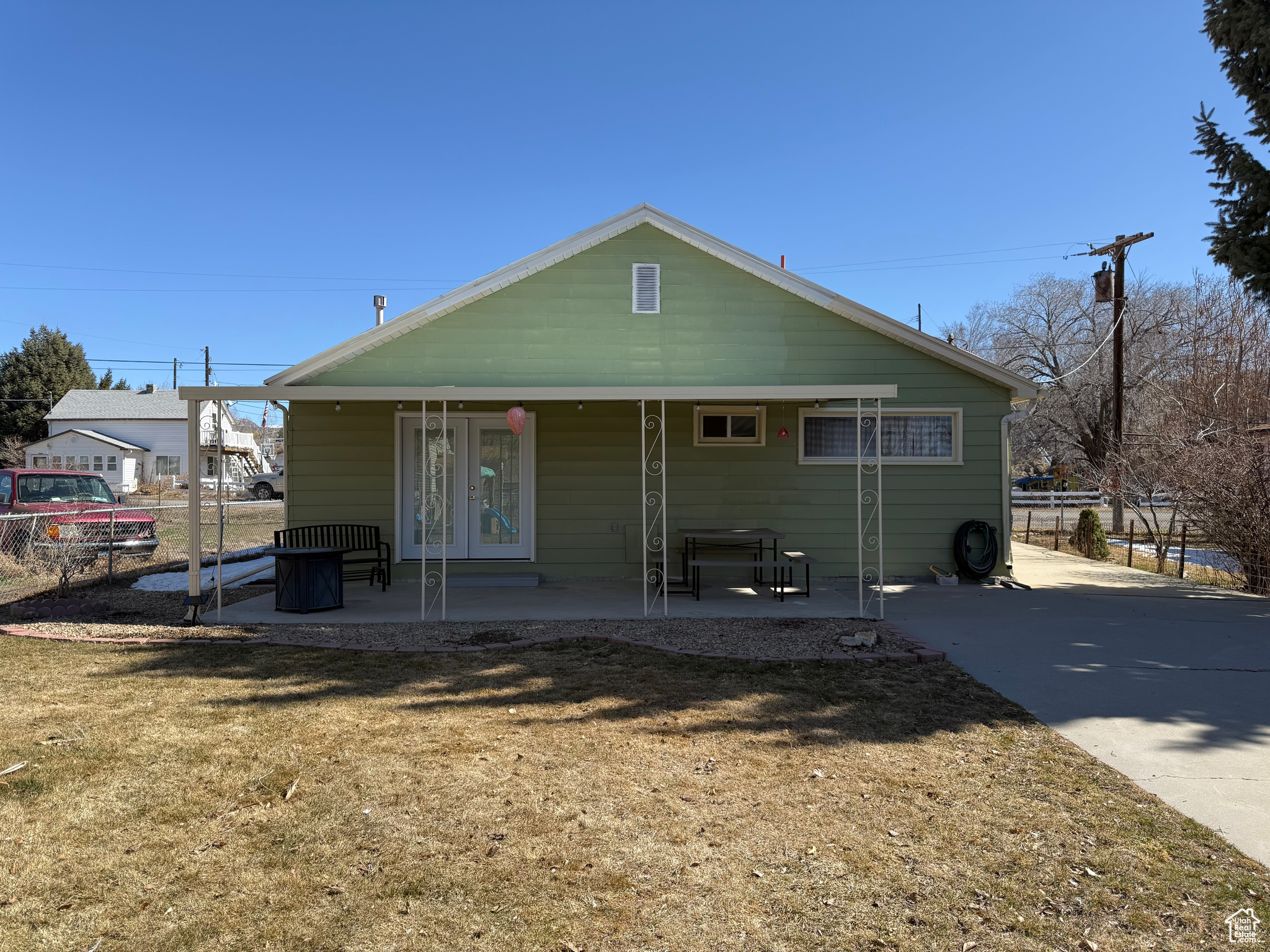 Back of property with fence and covered porch