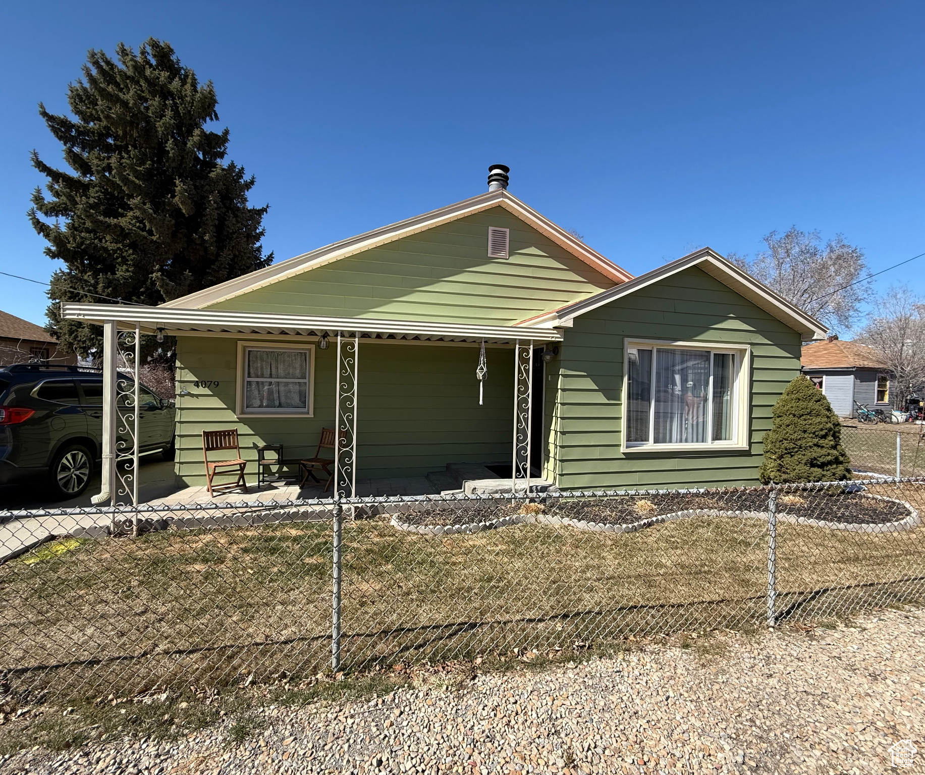 View of front of property featuring covered porch and fence private yard