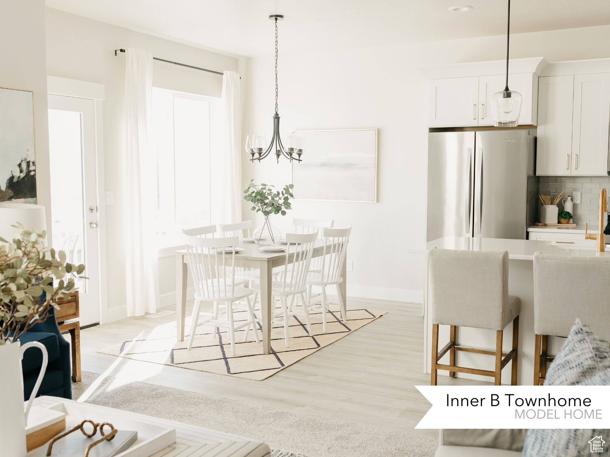 Dining area with an inviting chandelier, baseboards, and light wood-type flooring