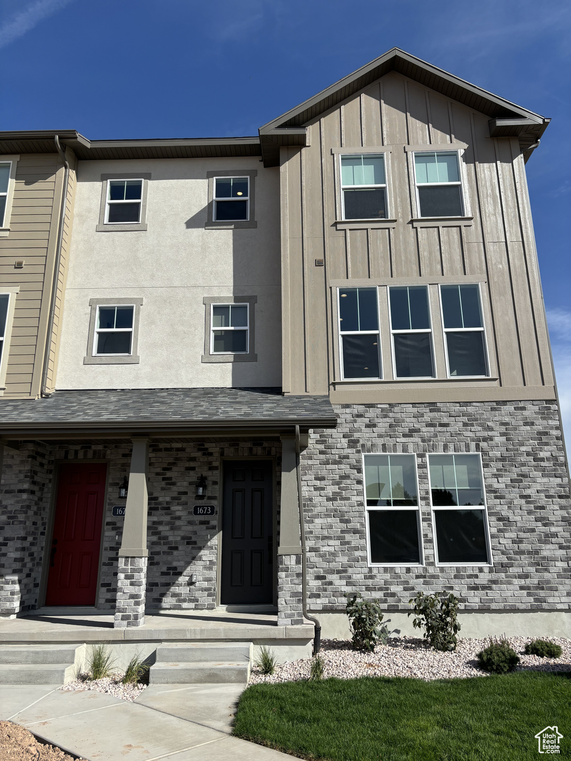 View of front of property with brick siding and board and batten siding