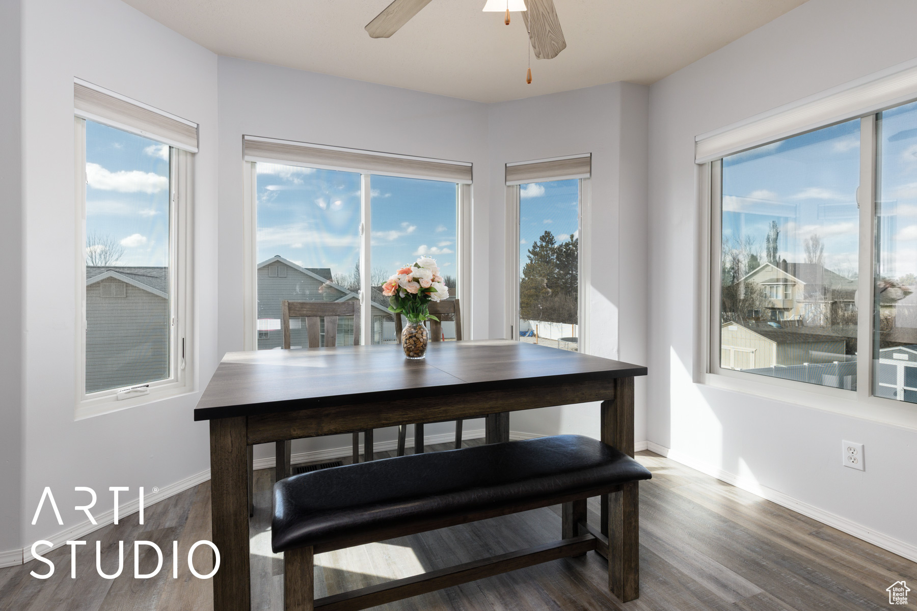 Dining space featuring ceiling fan, baseboards, and wood finished floors