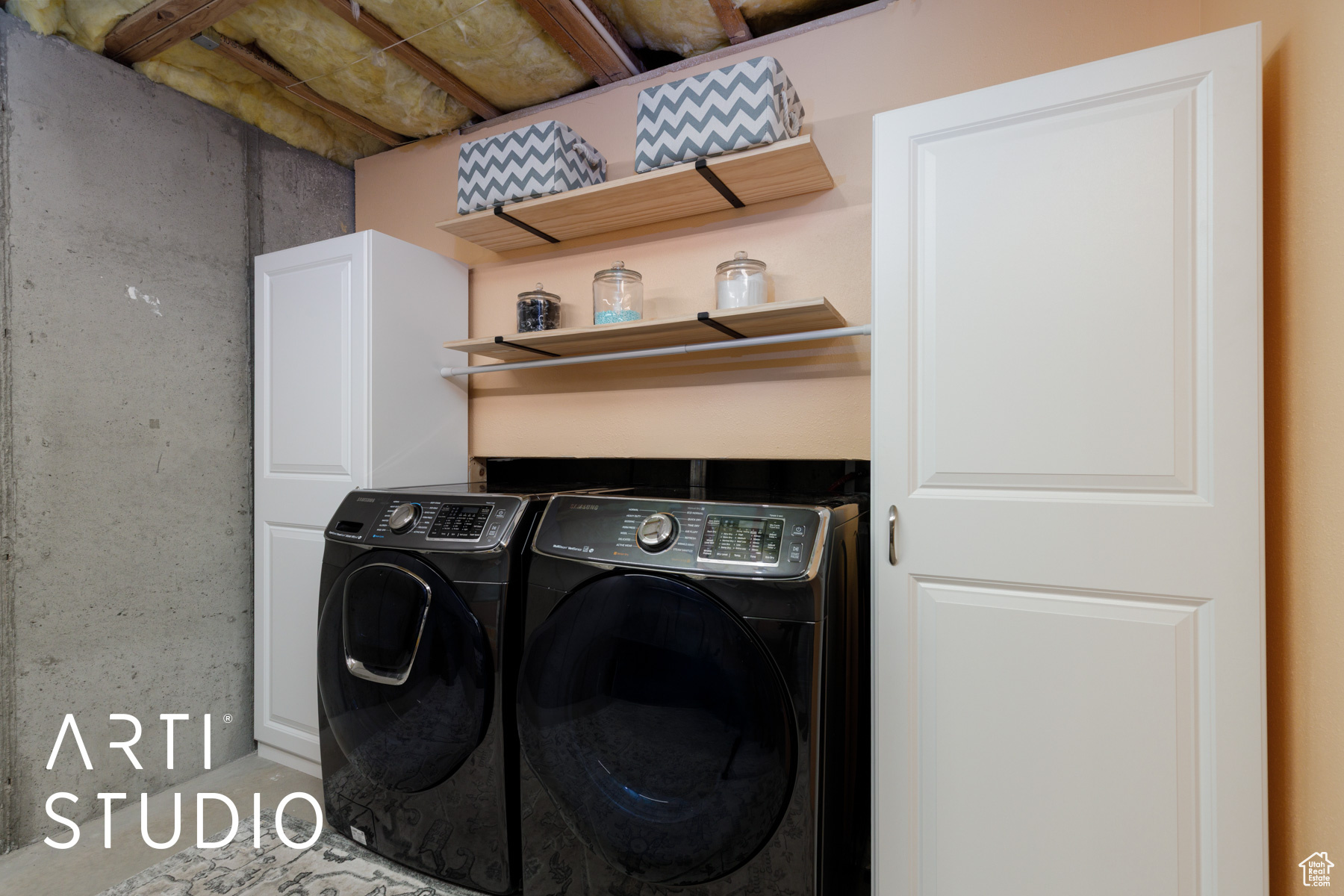 Laundry room featuring cabinet space and washer and clothes dryer