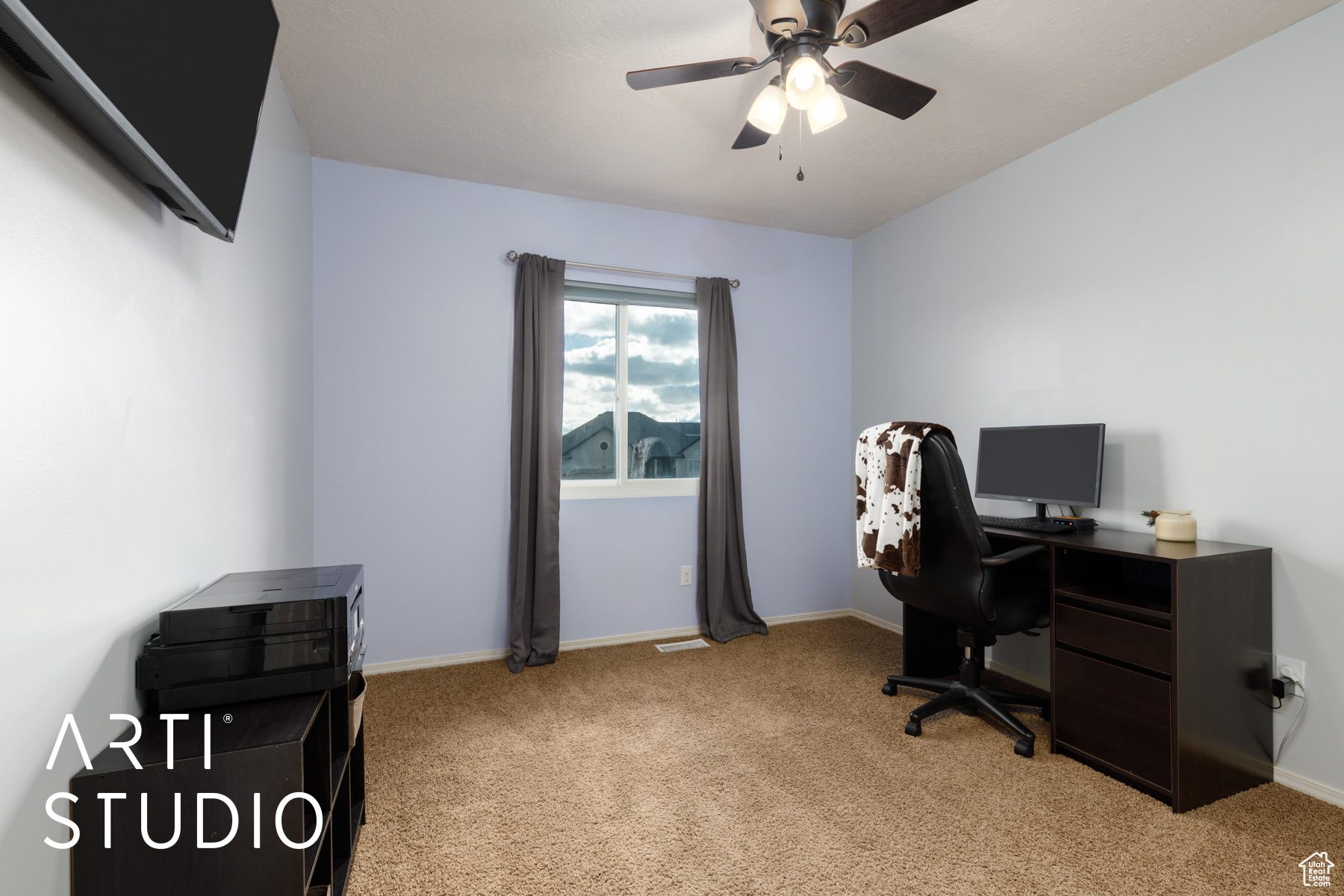 Office space with a ceiling fan, light colored carpet, and baseboards