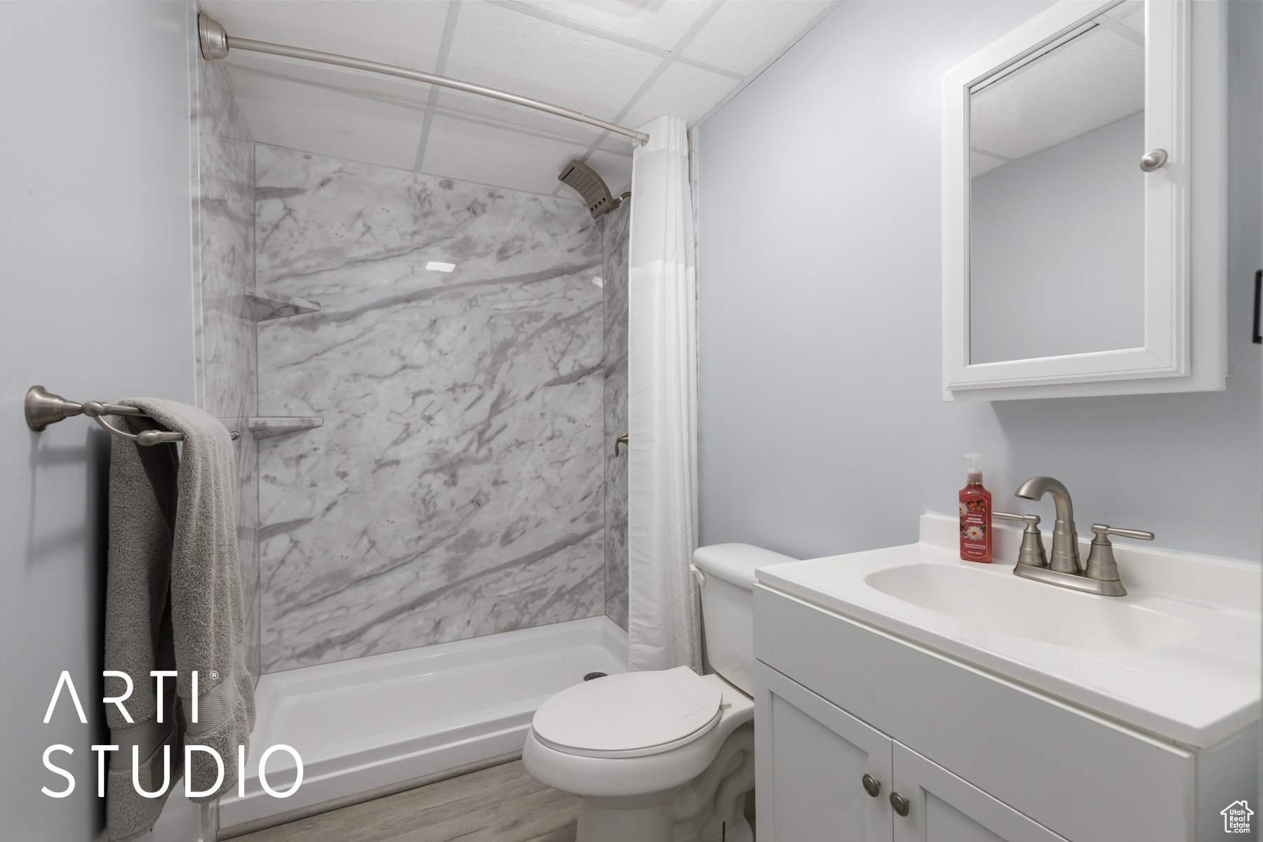 Full bathroom featuring a paneled ceiling, toilet, a stall shower, and vanity